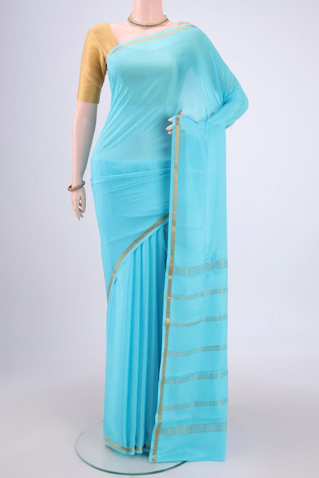 Sky Blue Mysore Crepe Saree with Plain Body and Zari Border.  displayed on a mannequin