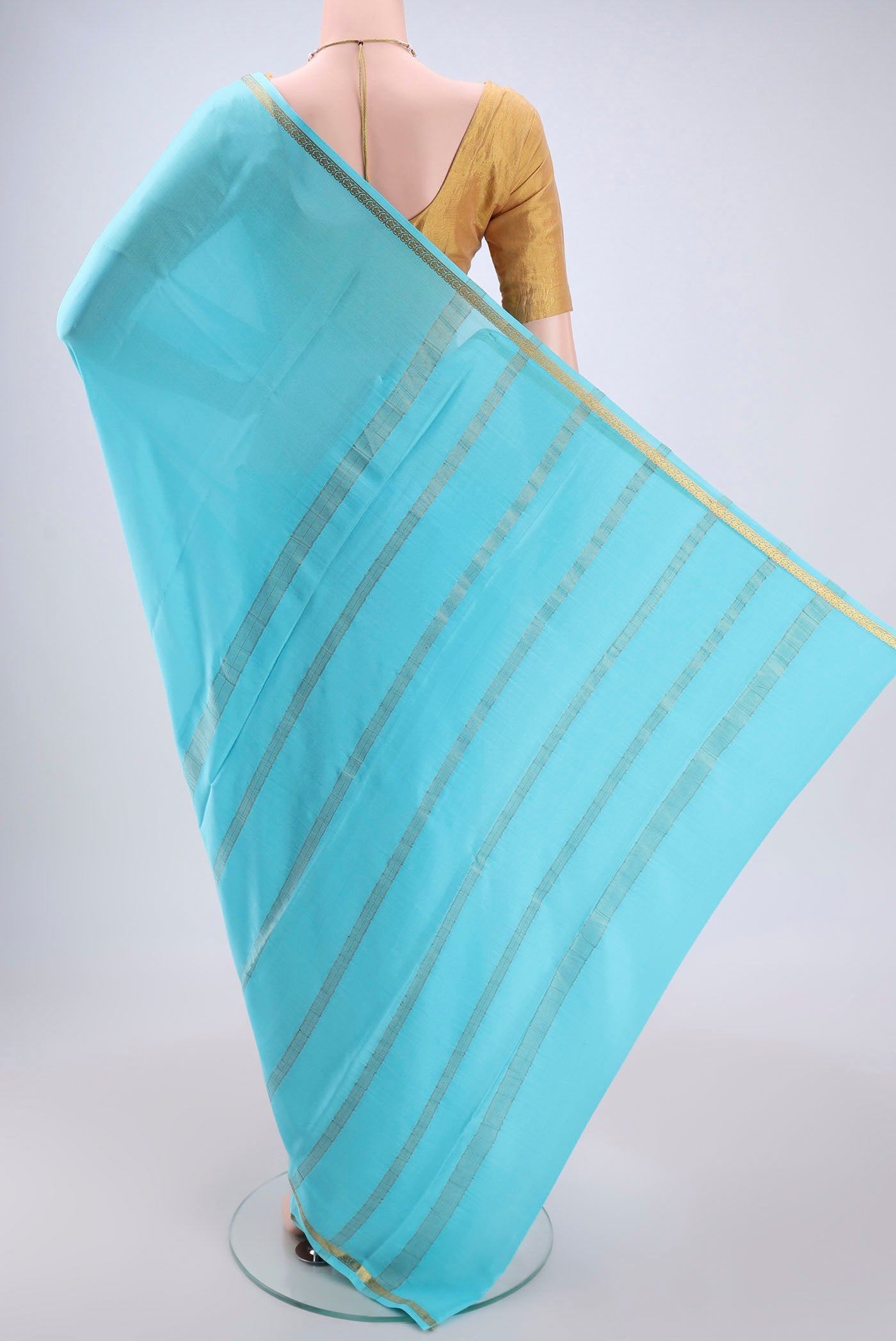 Flat view of Sky Blue Mysore Crepe Saree with Plain Body and Zari Border. 