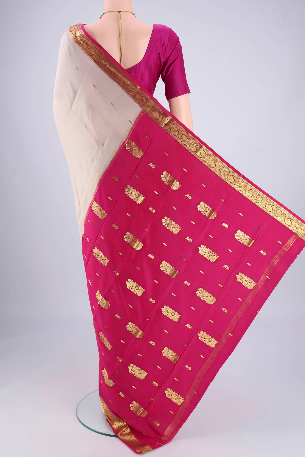 Flat view of Off White Mysore Crepe Saree with Zari Butta on the body and Zari Border. 