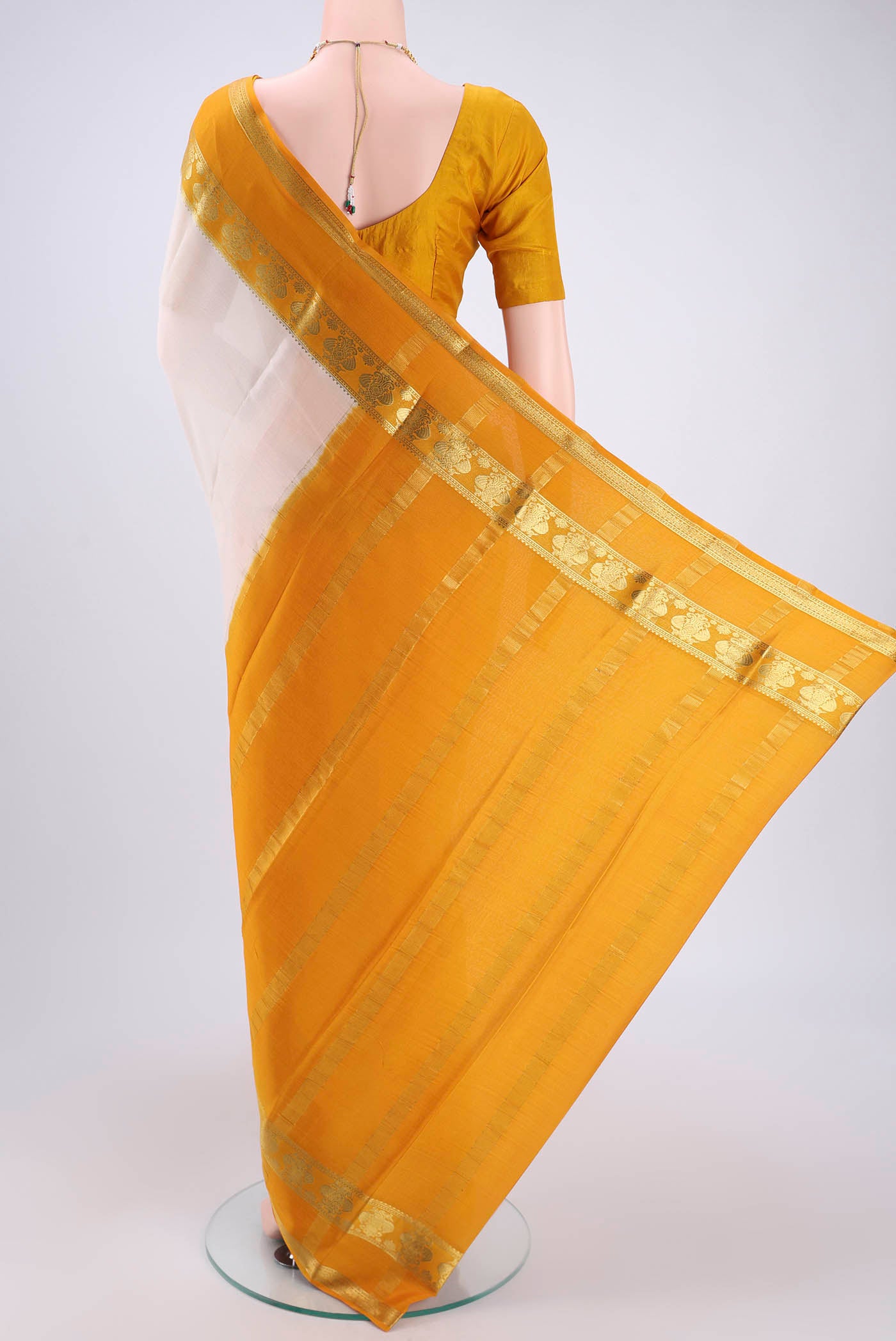 Flat view of Cream Mysore Crepe Saree with Plain Body and Zari Border. 