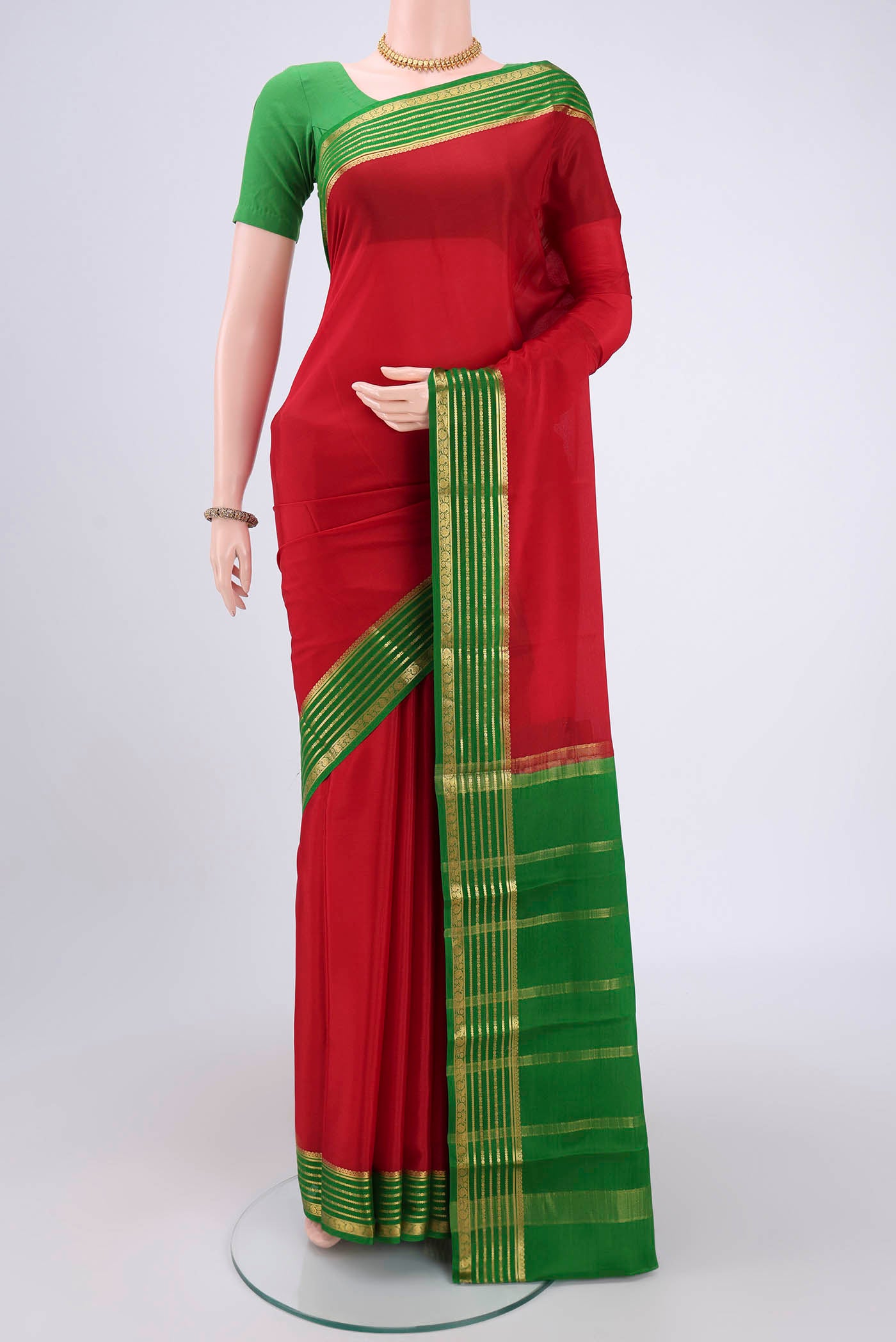 Red Mysore Crepe Saree with Plain Body and Zari Border.  displayed on a mannequin