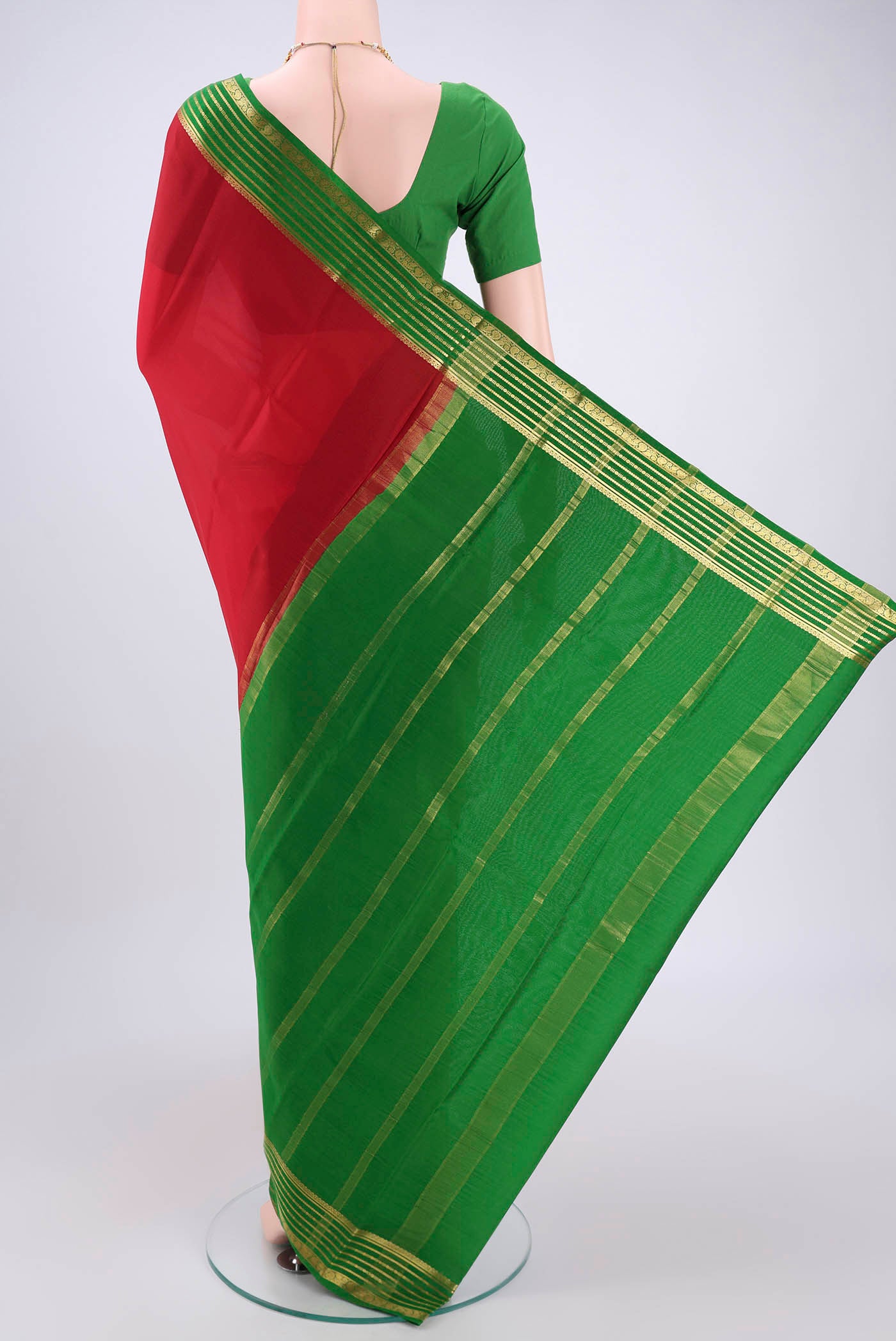Flat view of Red Mysore Crepe Saree with Plain Body and Zari Border. 