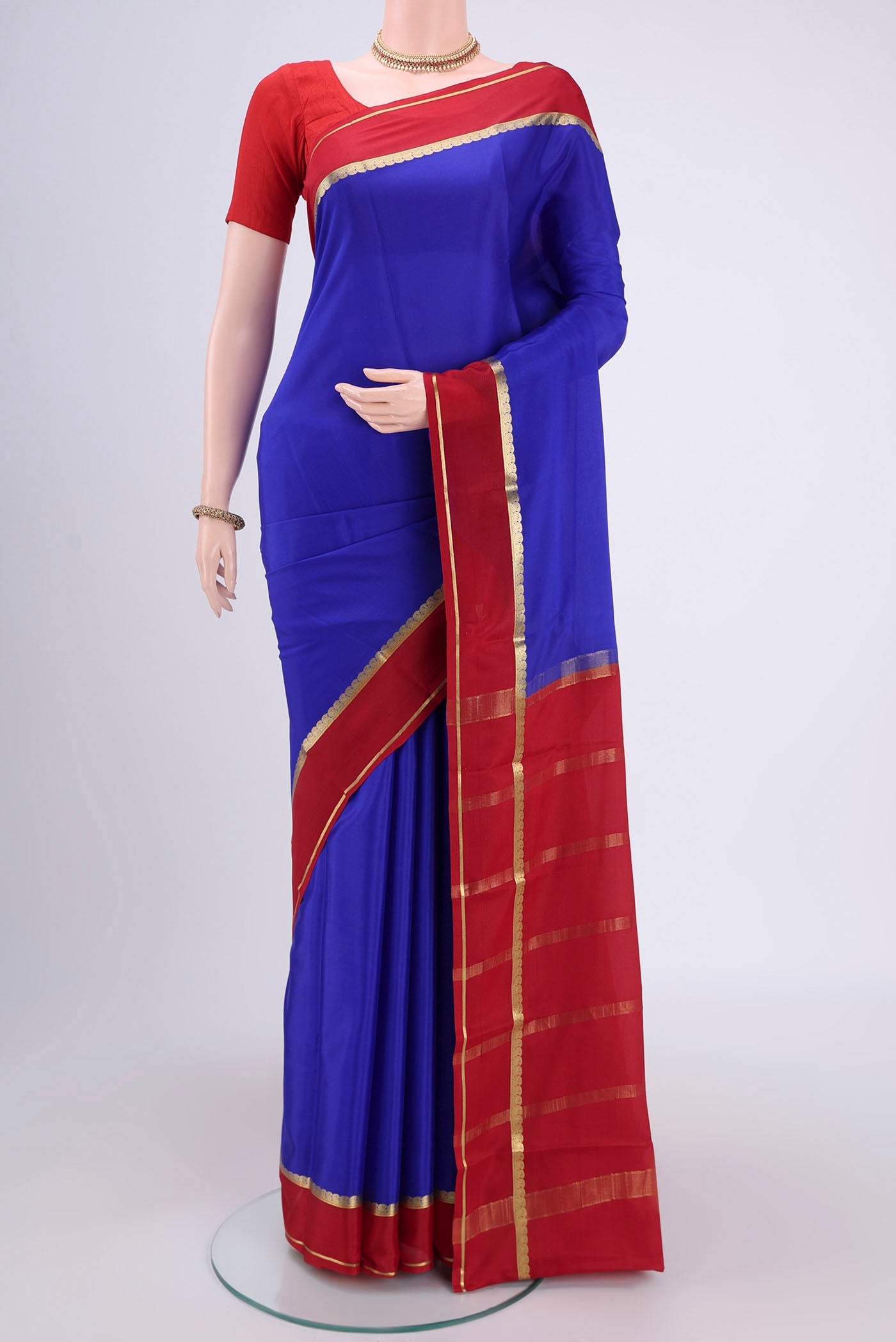 Royal Blue Mysore Crepe Saree with Plain Body and Zari Border.  displayed on a mannequin