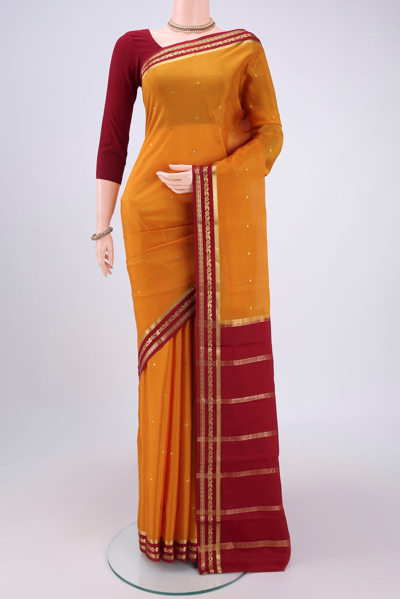 Yellow Mysore Crepe Saree with Plain Body and Zari Border.  displayed on a mannequin
