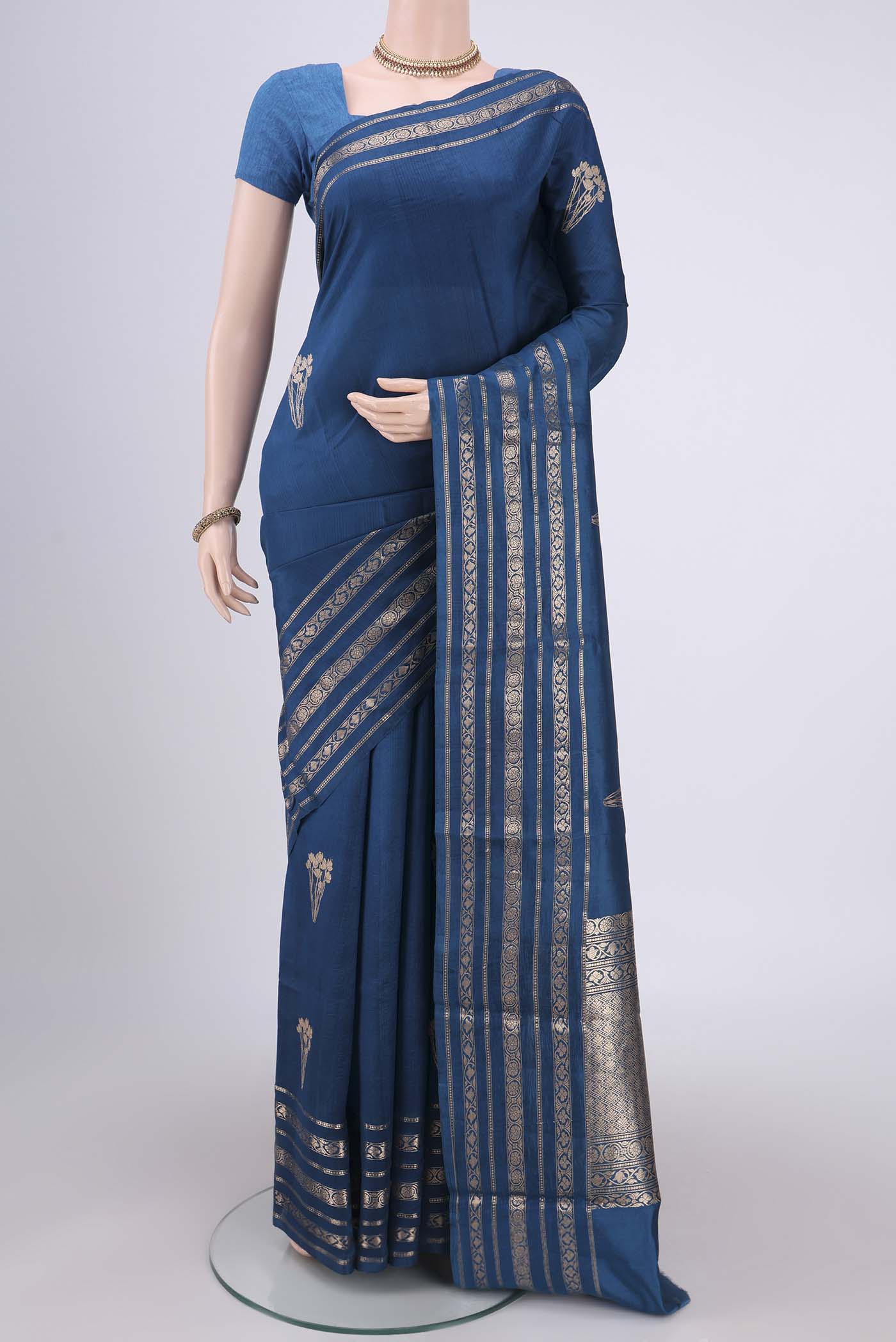 Blue Banarasi Katan Silk Saree with Zari Butta on the body and Zari Border.  displayed on a mannequin