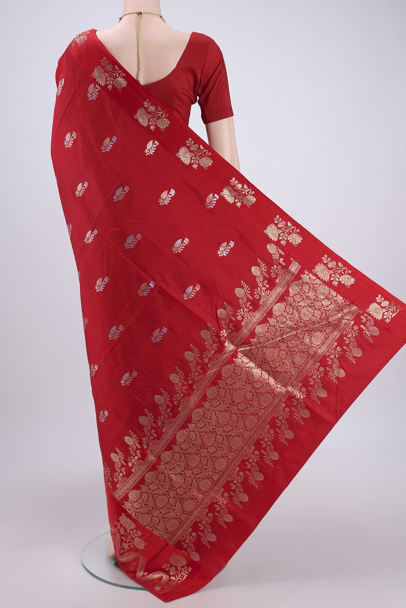 Flat view of Red Banarasi Katan Silk Saree with Zari Butta on the body and Zari Border. 