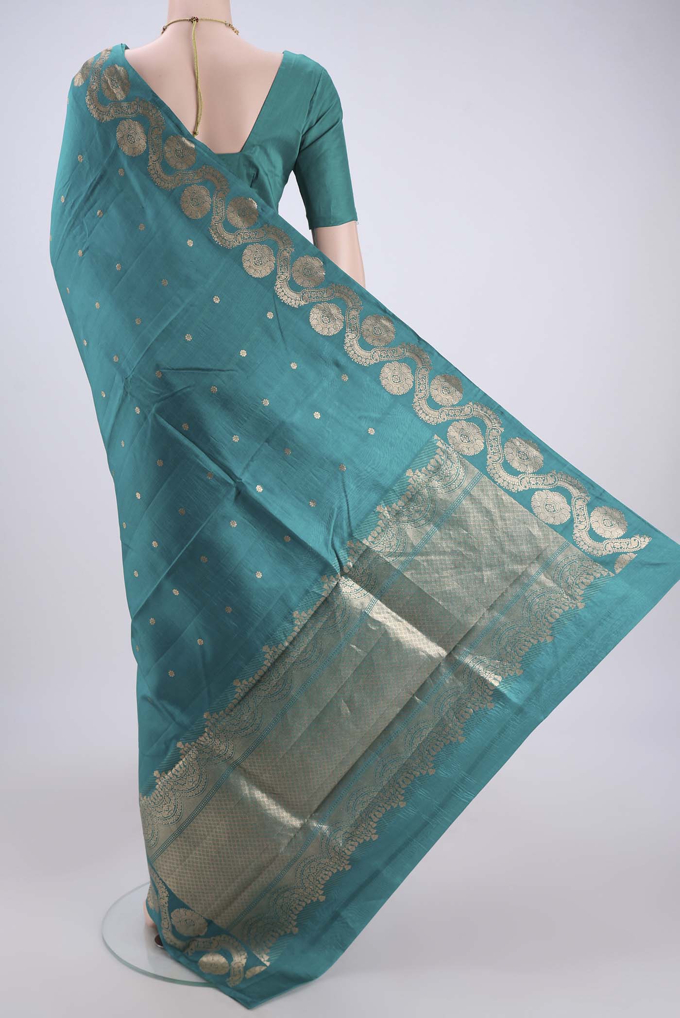 Flat view of Turquoise Banarasi Katan Silk Saree with Zari Butta on the body and Zari Border. 