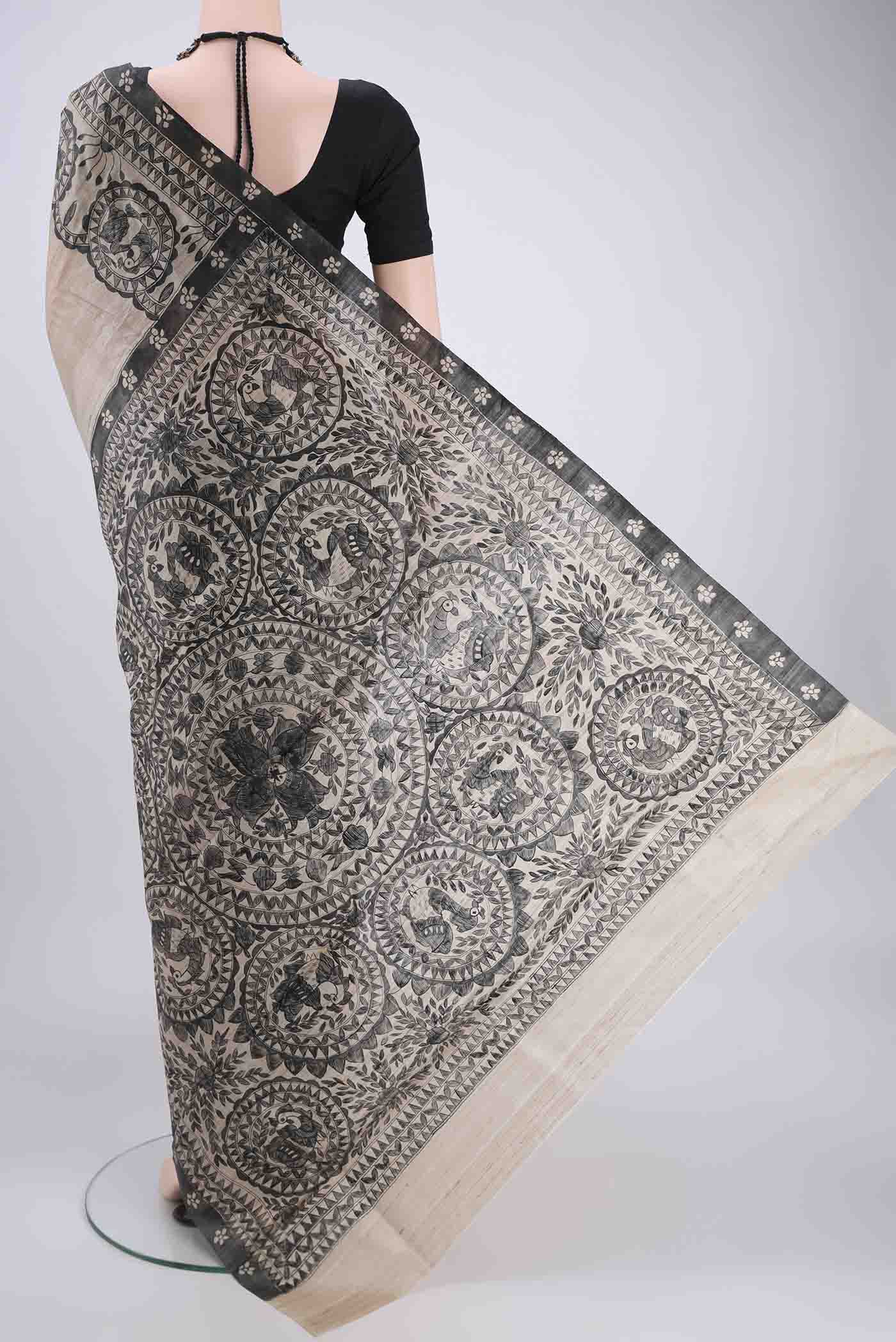 Flat view of Beige Tussar Silk Saree with Printed design on the body and Without Border. 