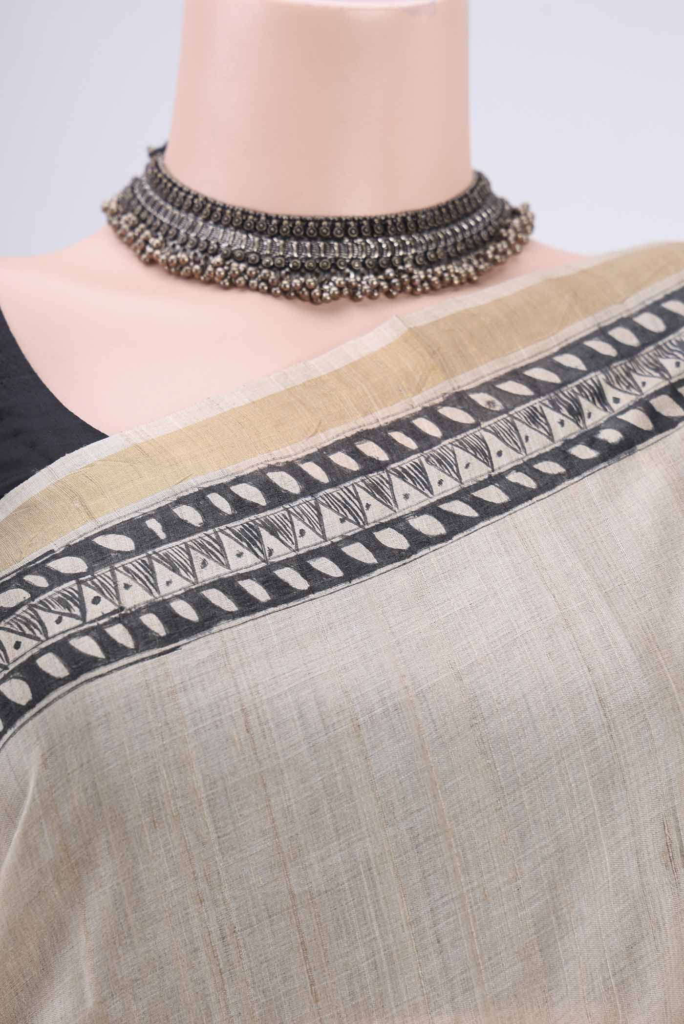 Border image of Beige Tussar Silk Saree with Printed design on the body and Zari Border. 