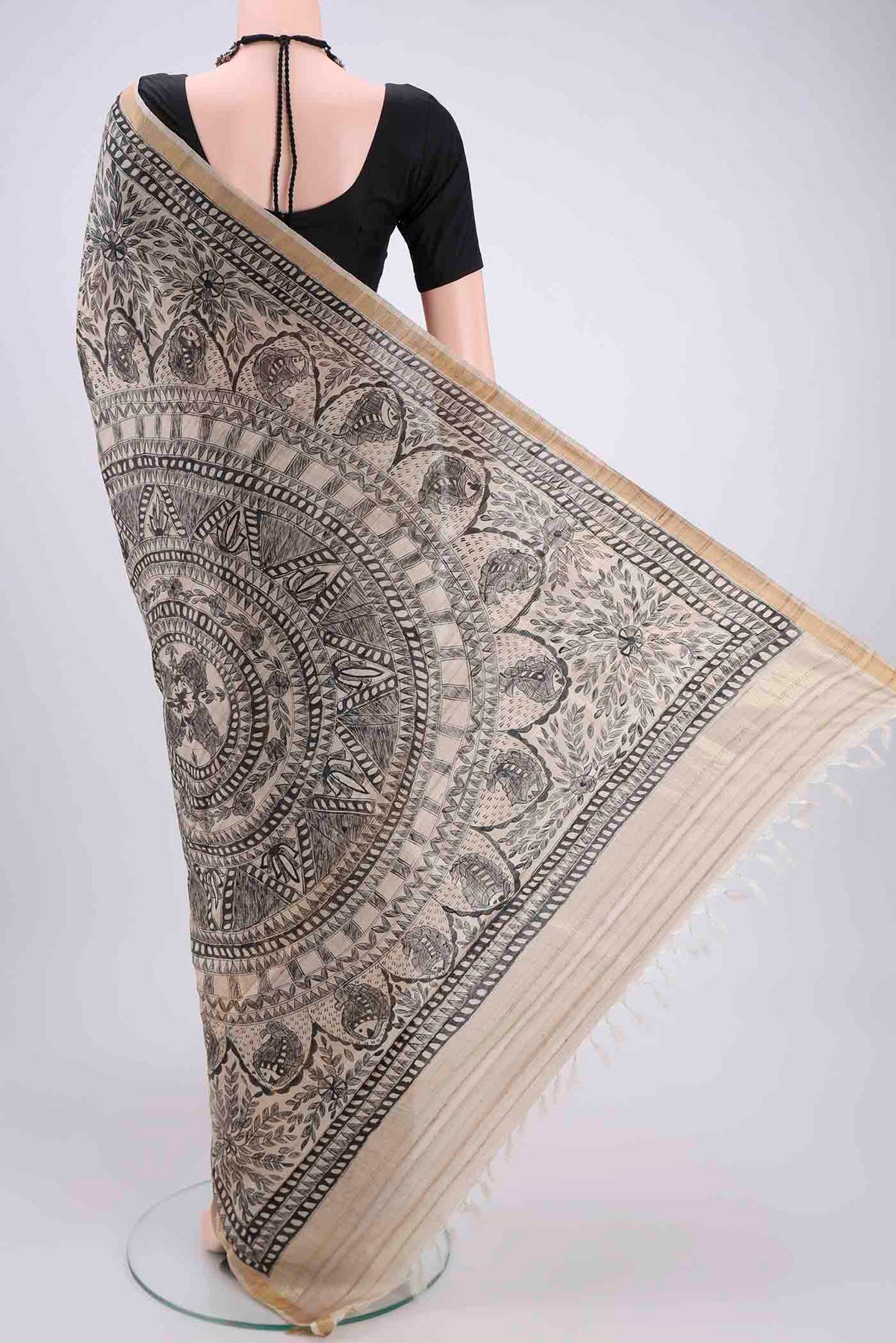 Flat view of Beige Tussar Silk Saree with Printed design on the body and Zari Border. 
