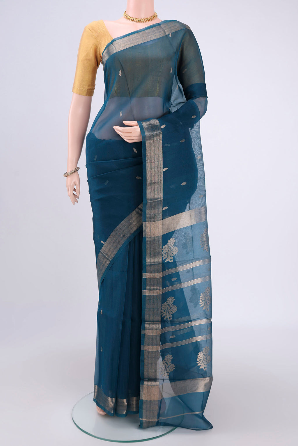 Turquoise Organza Silk Saree with Plain Body and Zari Border.  displayed on a mannequin