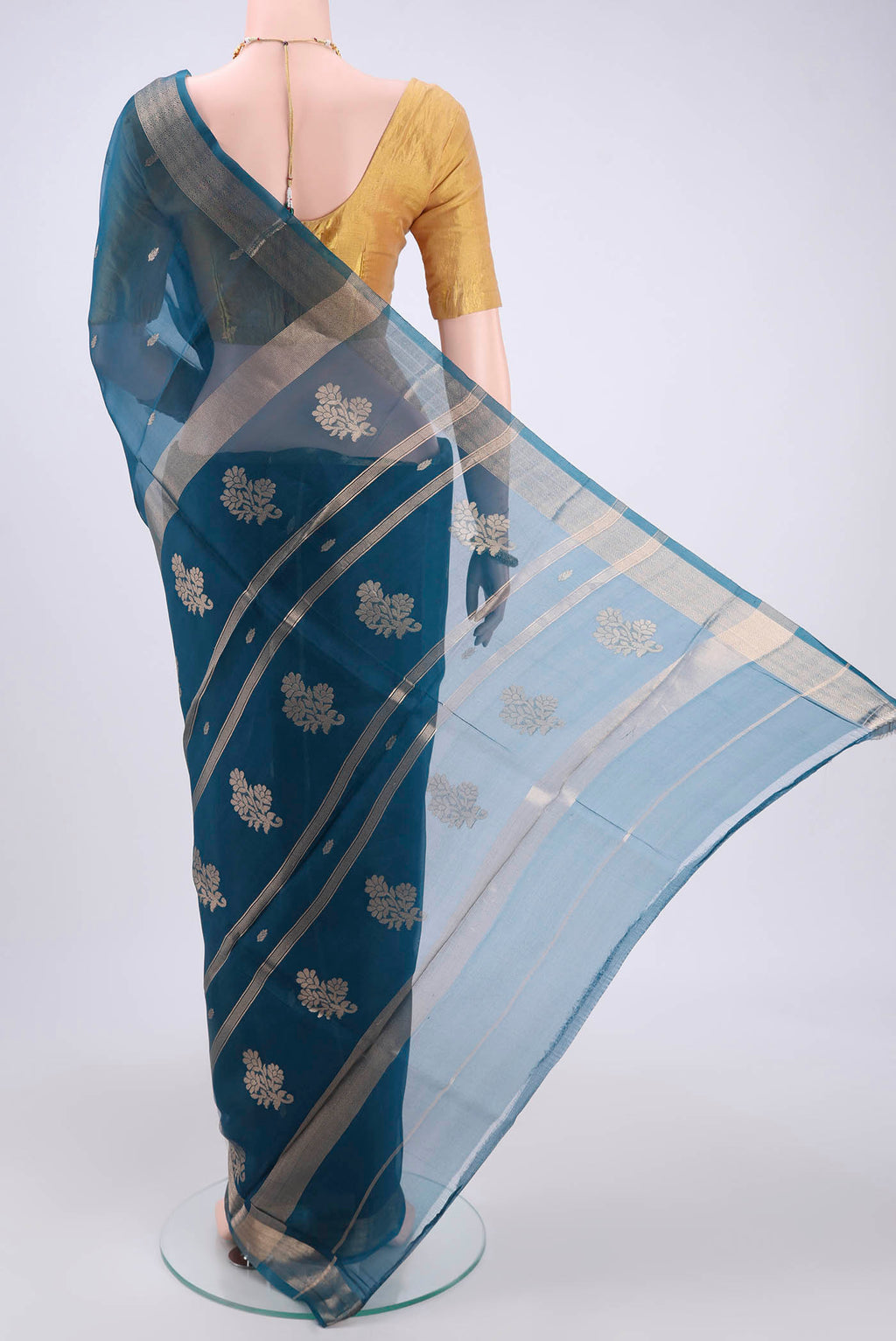 Flat view of Turquoise Organza Silk Saree with Plain Body and Zari Border. 