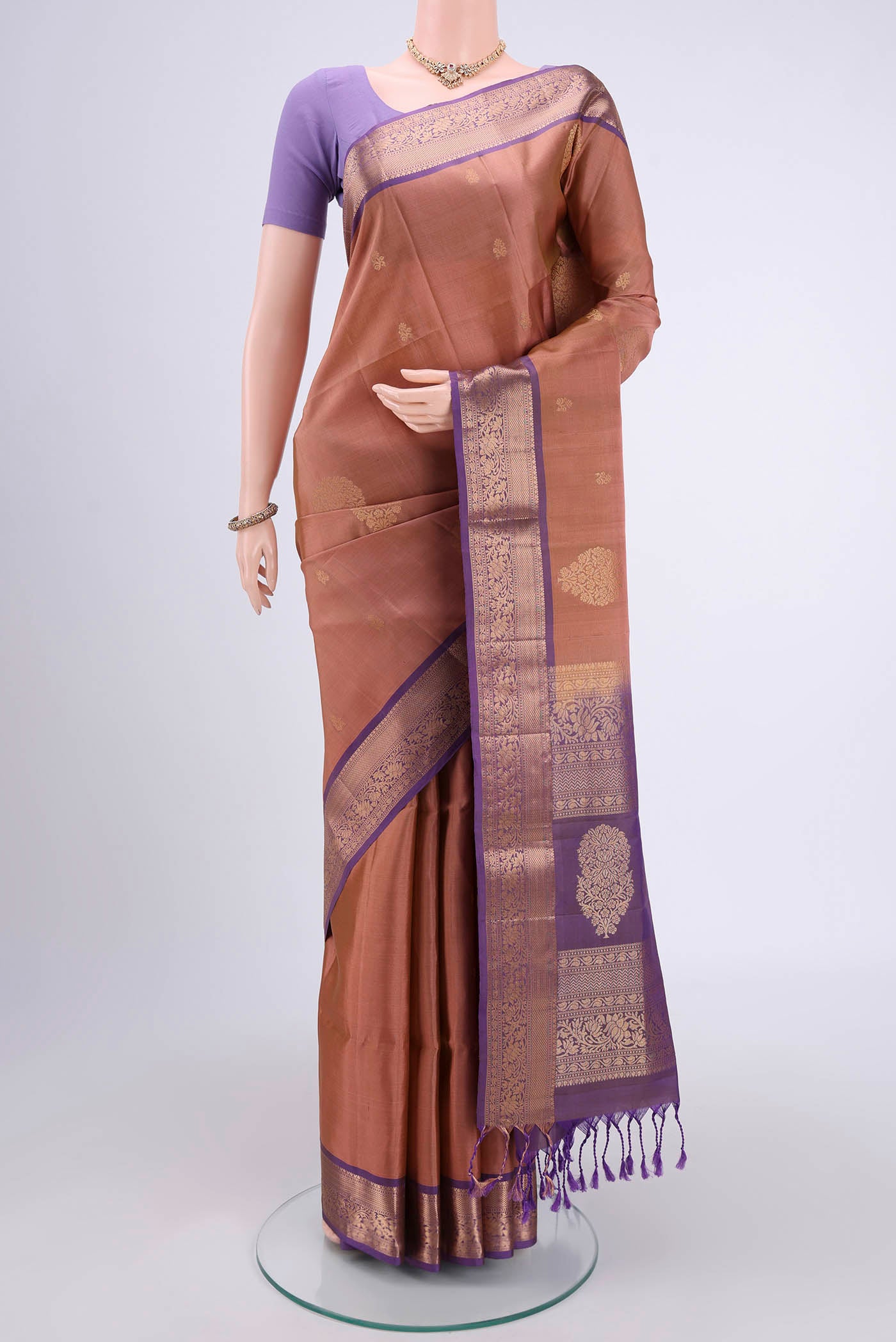 Rose Gold Soft Silk Saree with Zari Butta on the body and Zari Border.  displayed on a mannequin