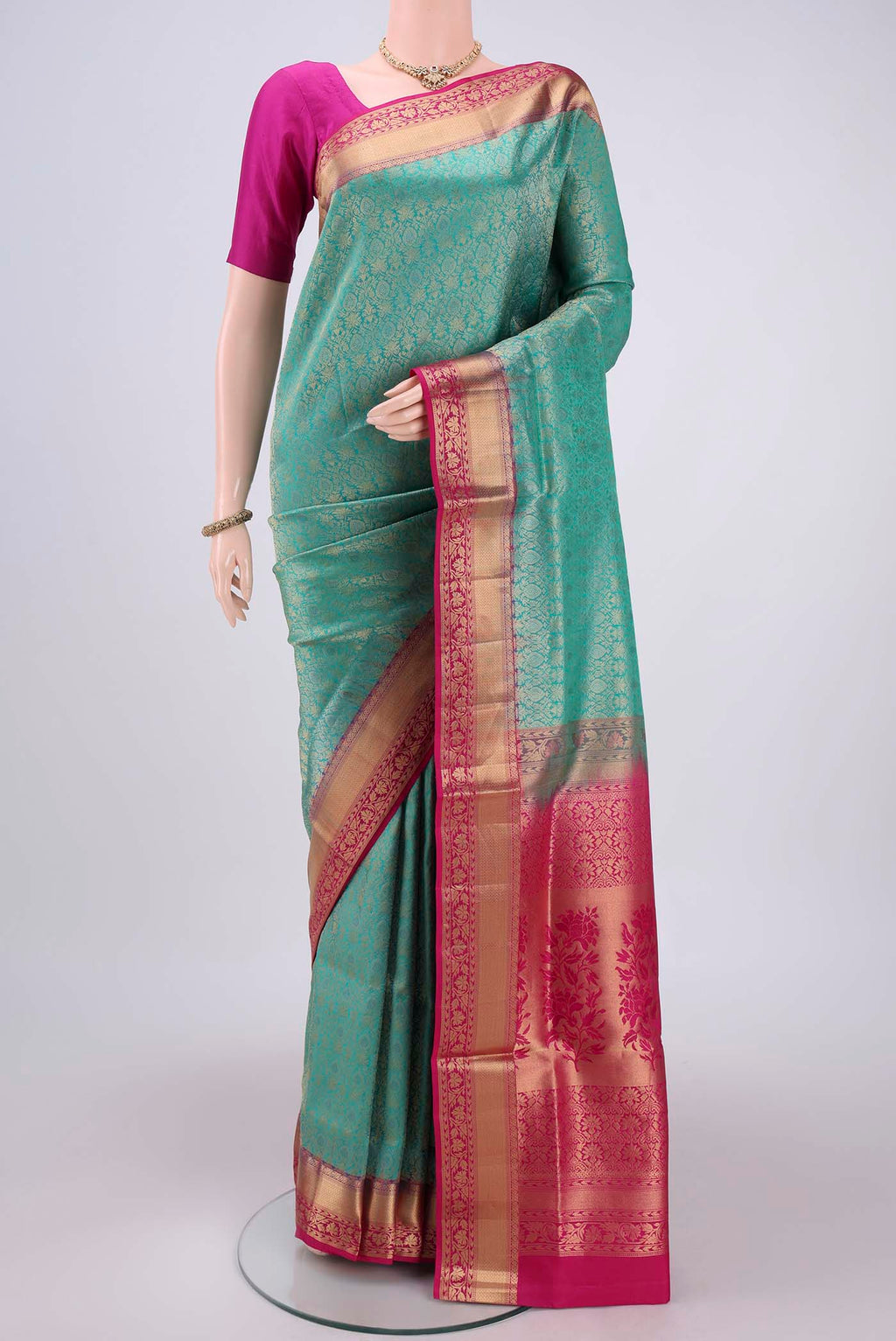 Turquoise Soft Silk Saree with Zari Brocade on the body and Zari Border.  displayed on a mannequin