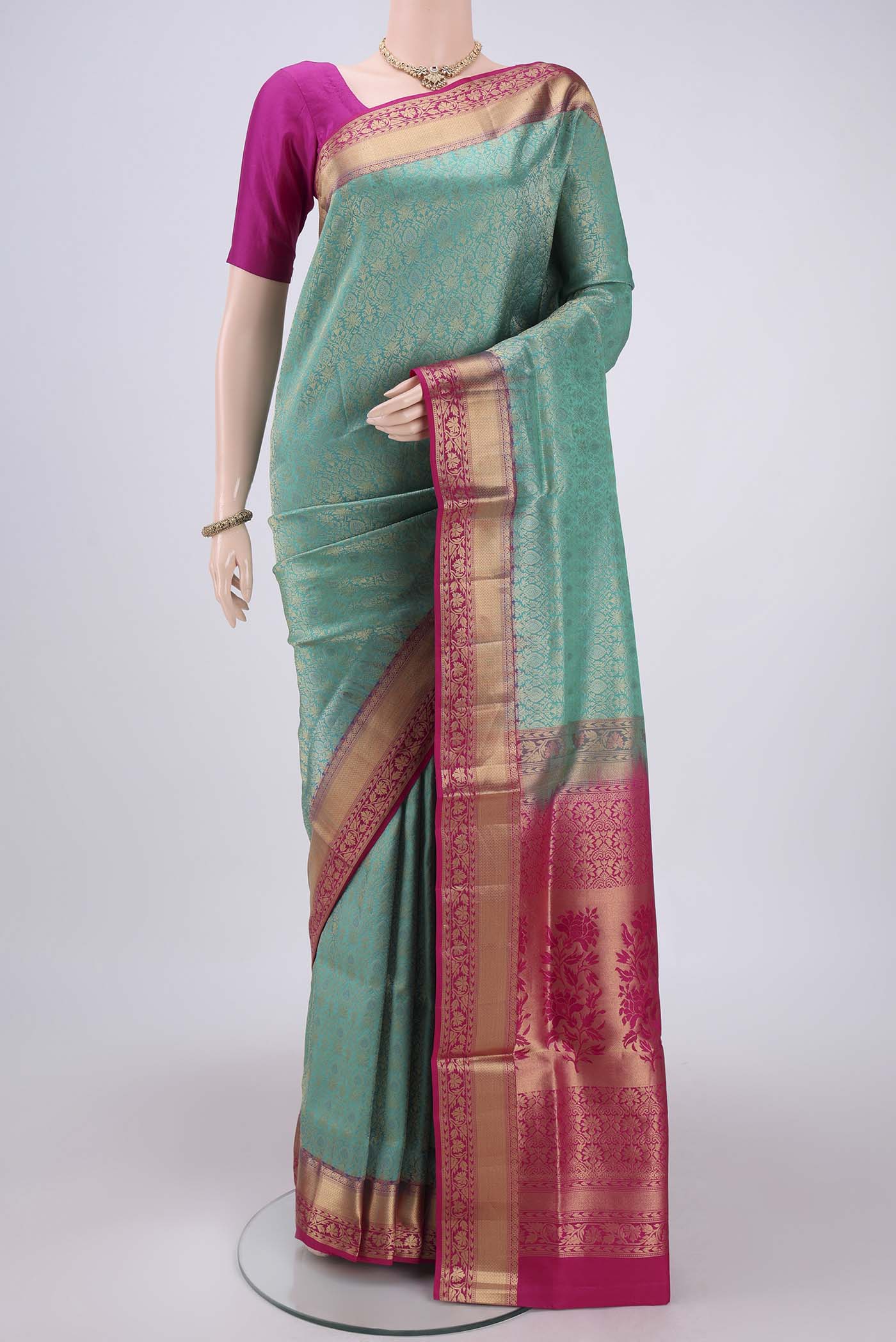 Turquoise Soft Silk Saree with Zari Brocade on the body and Zari Border.  displayed on a mannequin