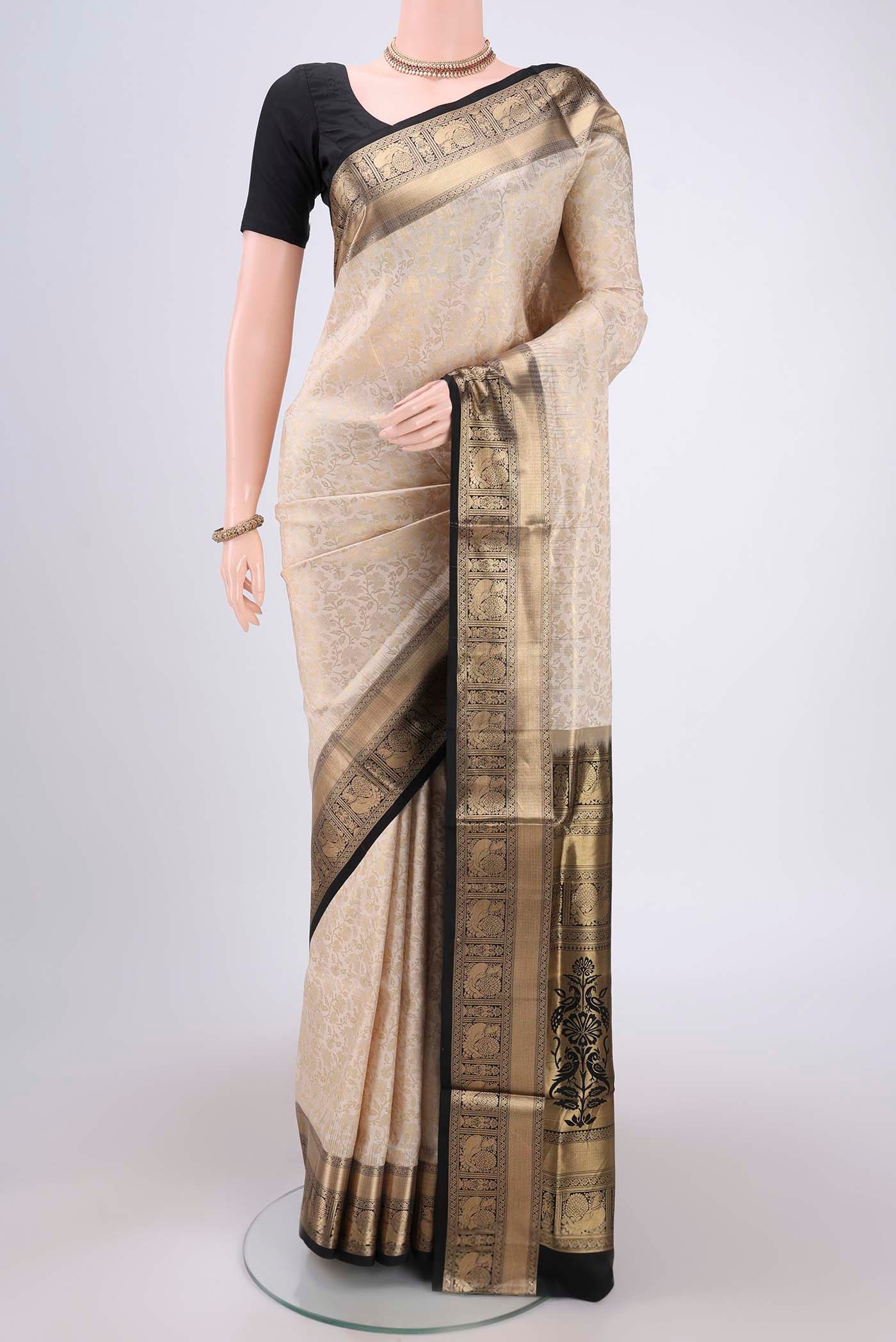 Cream Dual Tone Soft Silk Saree with Zari Brocade on the body and Zari Border.  displayed on a mannequin
