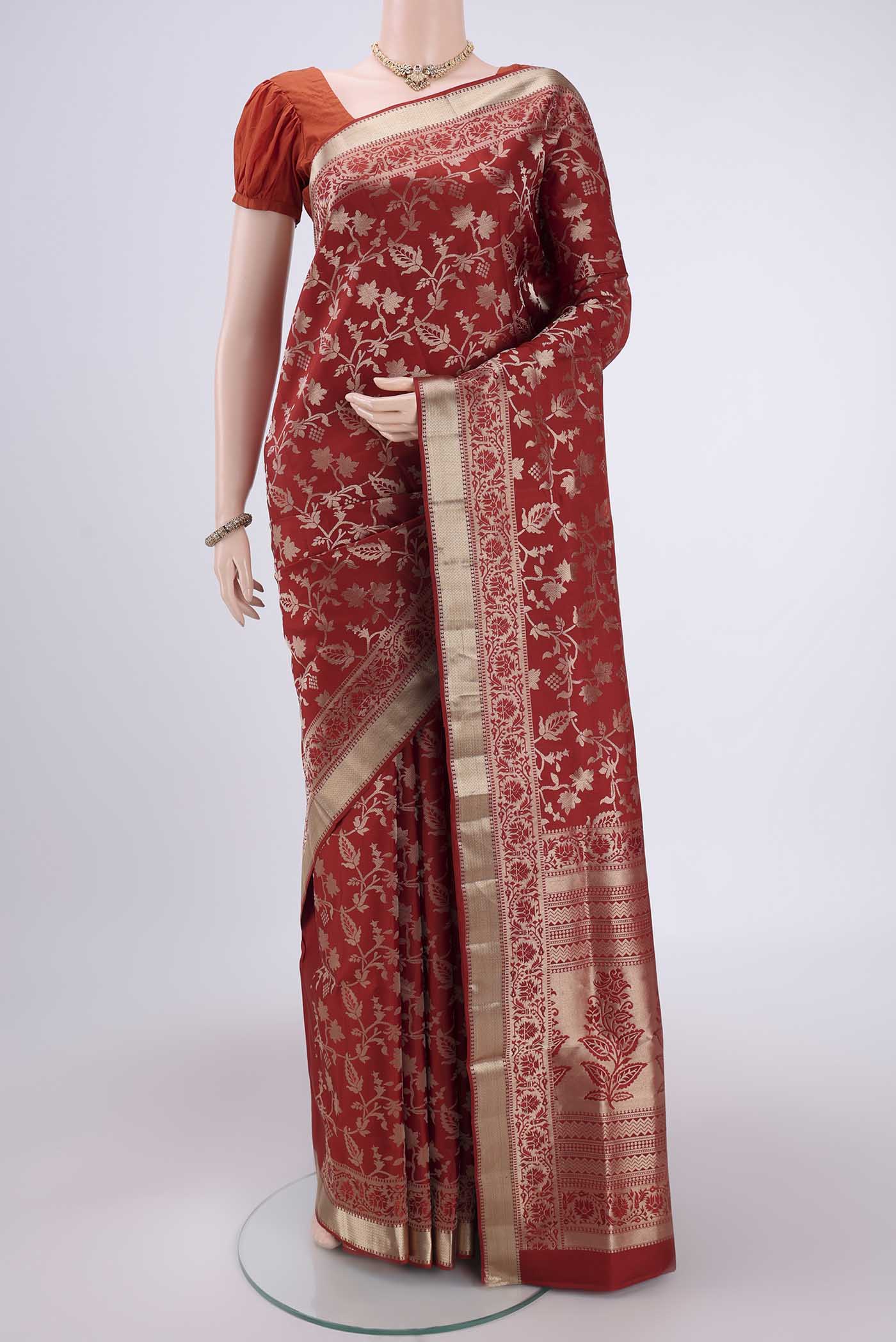 Rust Soft Silk Saree with Zari Brocade on the body and Zari Border.  displayed on a mannequin