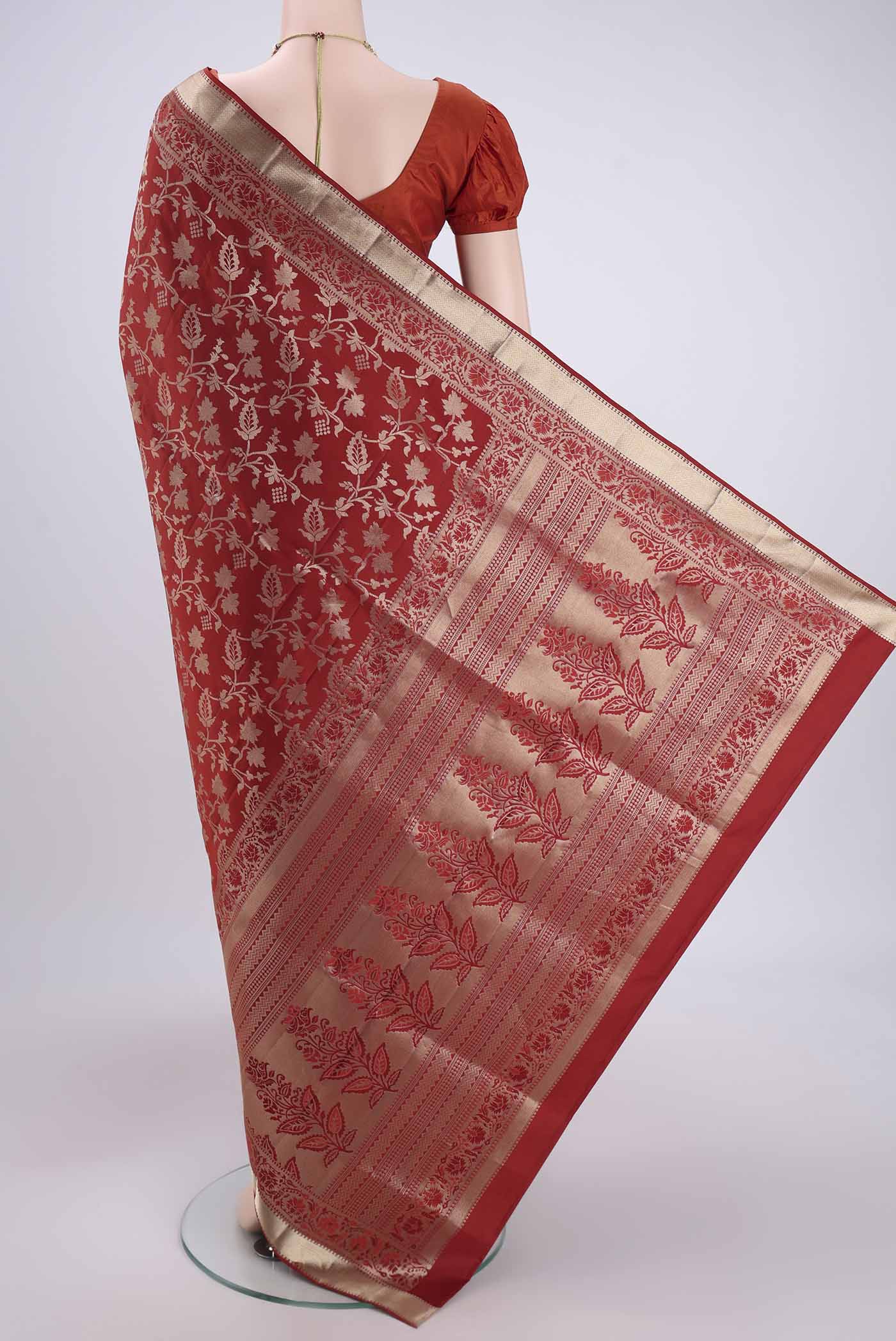 Flat view of Rust Soft Silk Saree with Zari Brocade on the body and Zari Border. 