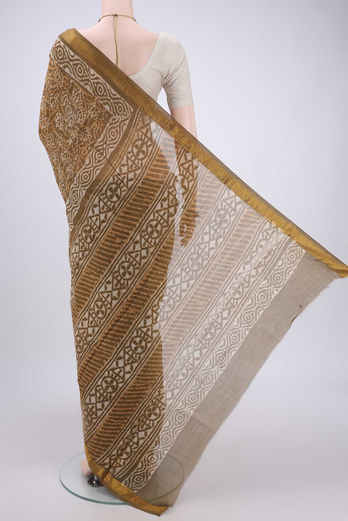 Flat view of Mustard Maheshwari Silk Cotton Saree with Batik Print on the body and Zari Border. 