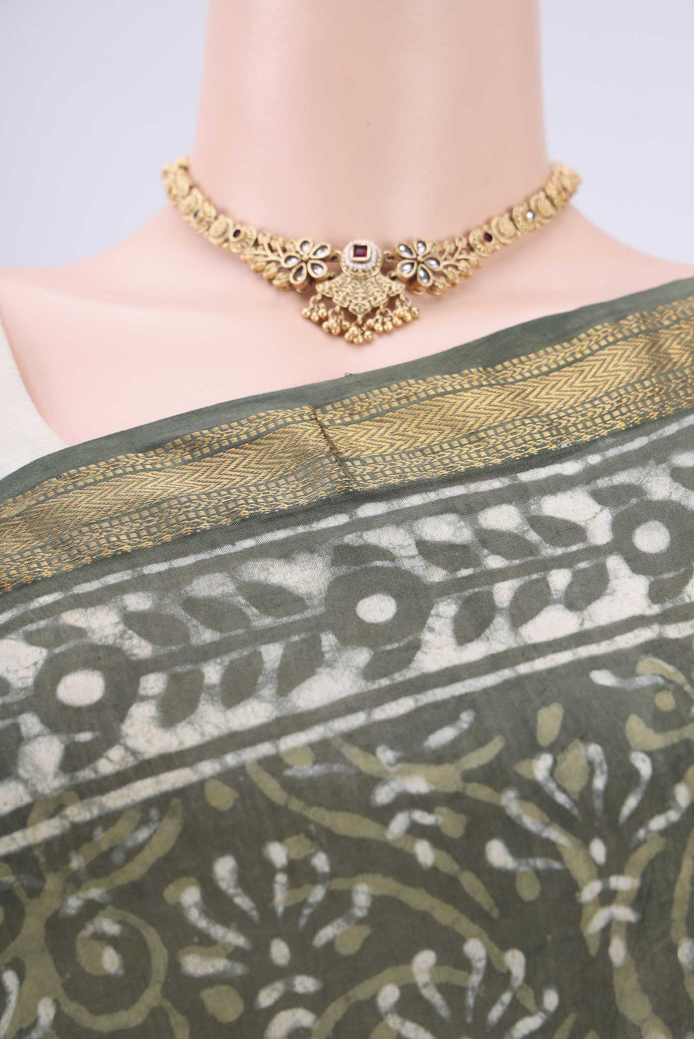Border image of Olive Green Maheshwari Silk Cotton Saree with Batik Print on the body and Zari Border. 