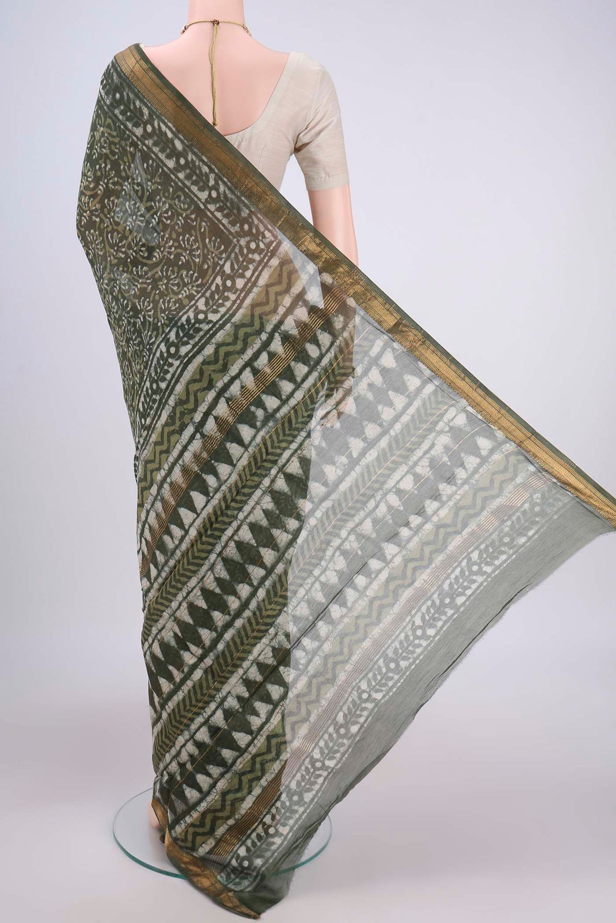Flat view of Olive Green Maheshwari Silk Cotton Saree with Batik Print on the body and Zari Border. 