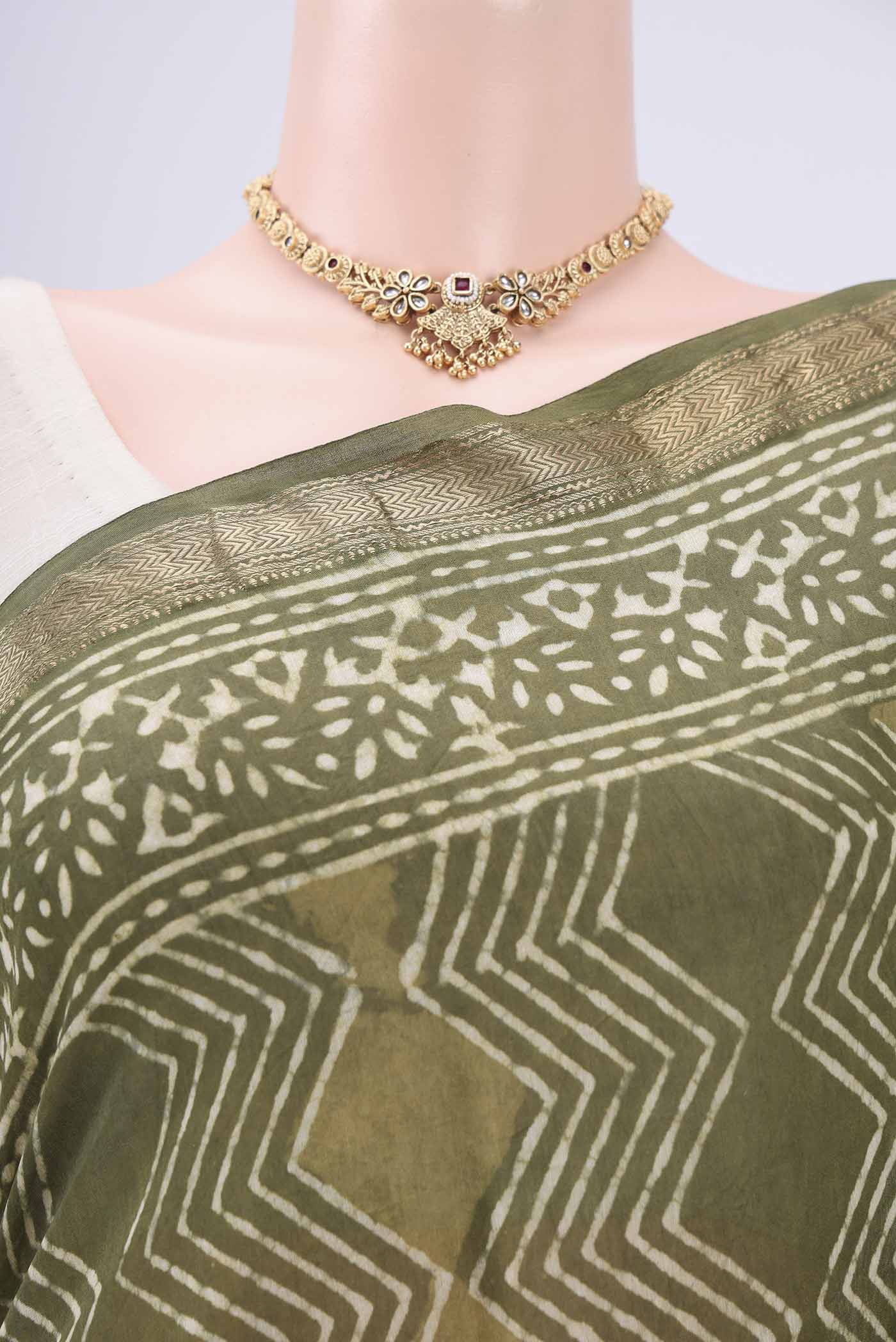 Border image of Olive Green Maheshwari Silk Cotton Saree with Batik Print on the body and Zari Border. 