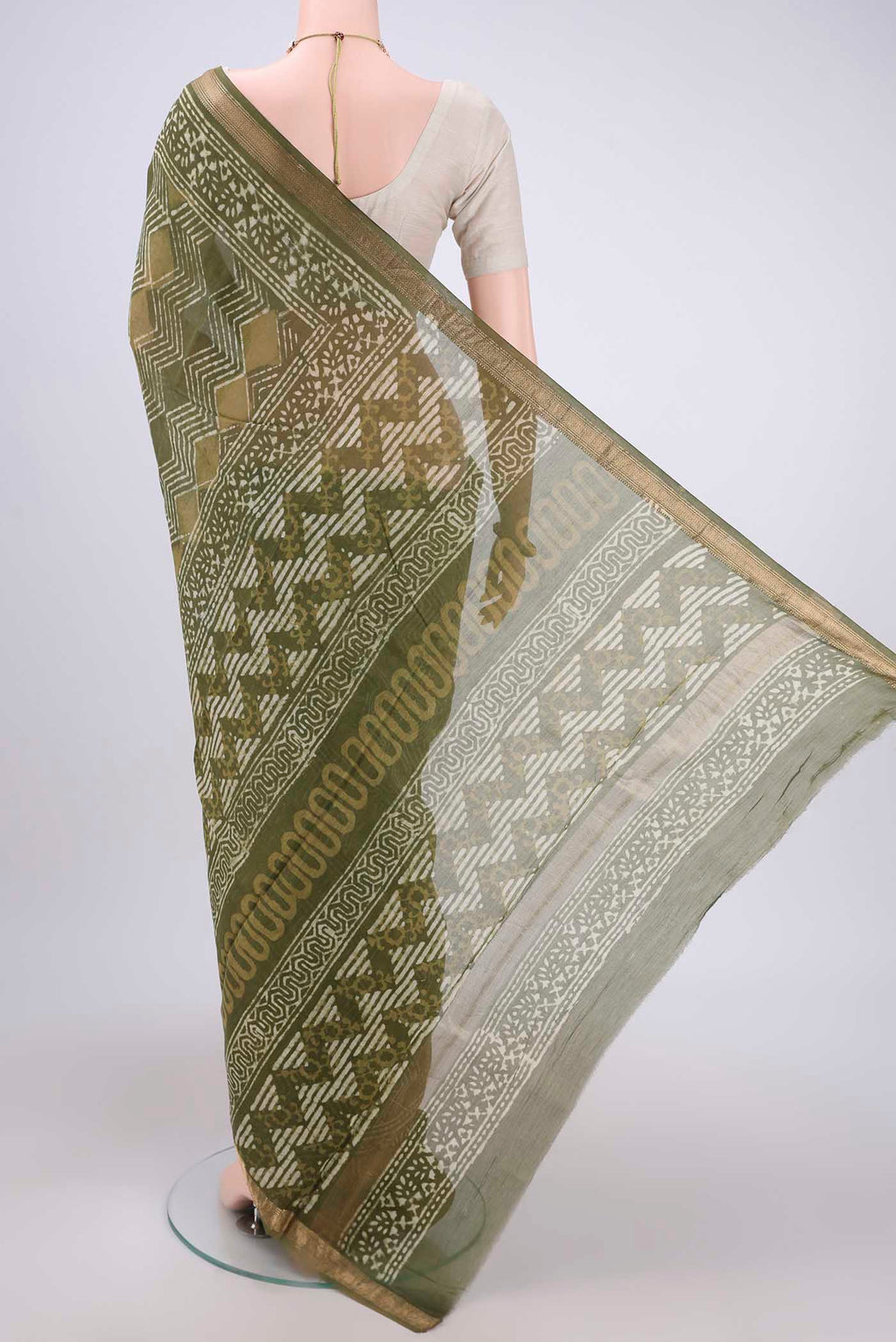 Flat view of Olive Green Maheshwari Silk Cotton Saree with Batik Print on the body and Zari Border. 