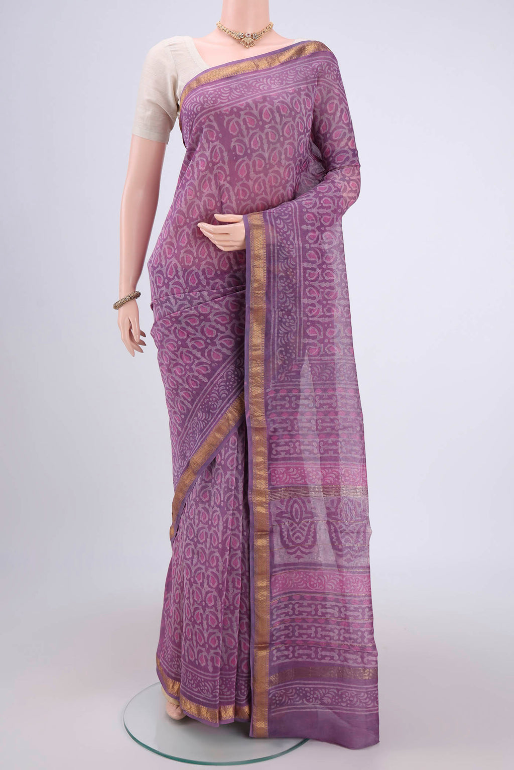 Mauve Maheshwari Silk Cotton Saree with Batik Print on the body and Zari Border.  displayed on a mannequin