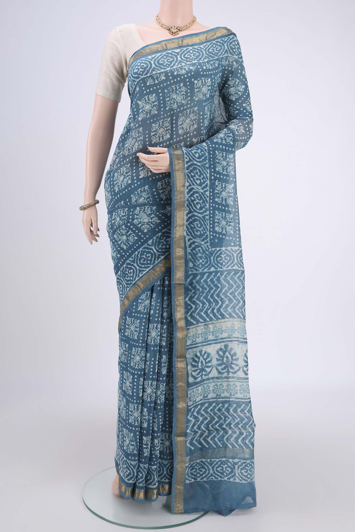 Blue Maheshwari Silk Cotton Saree with Batik Print on the body and Zari Border.  displayed on a mannequin