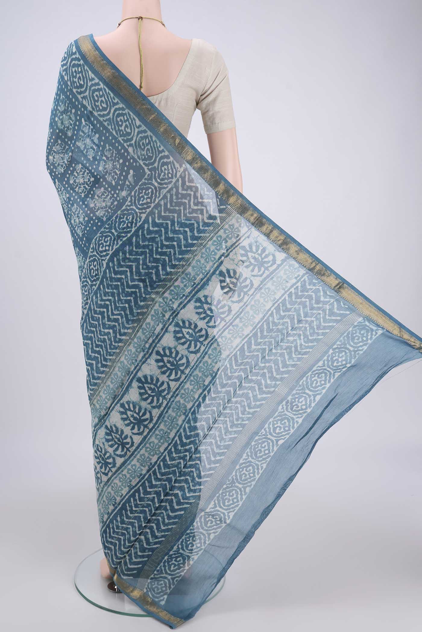 Flat view of Blue Maheshwari Silk Cotton Saree with Batik Print on the body and Zari Border. 