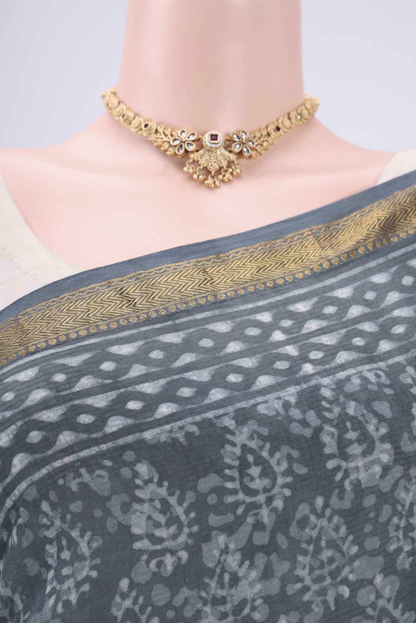 Border image of Sage Green Maheshwari Silk Cotton Saree with Batik Print on the body and Zari Border. 