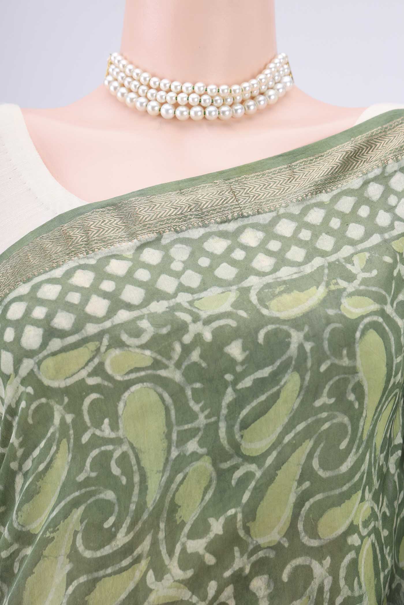 Border image of Olive Green Maheshwari Silk Cotton Saree with Batik Print on the body and Zari Border. 