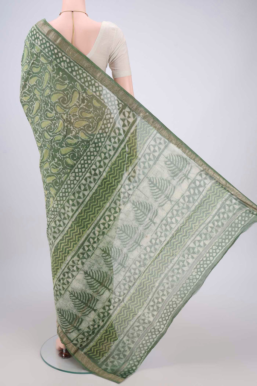 Flat view of Olive Green Maheshwari Silk Cotton Saree with Batik Print on the body and Zari Border. 