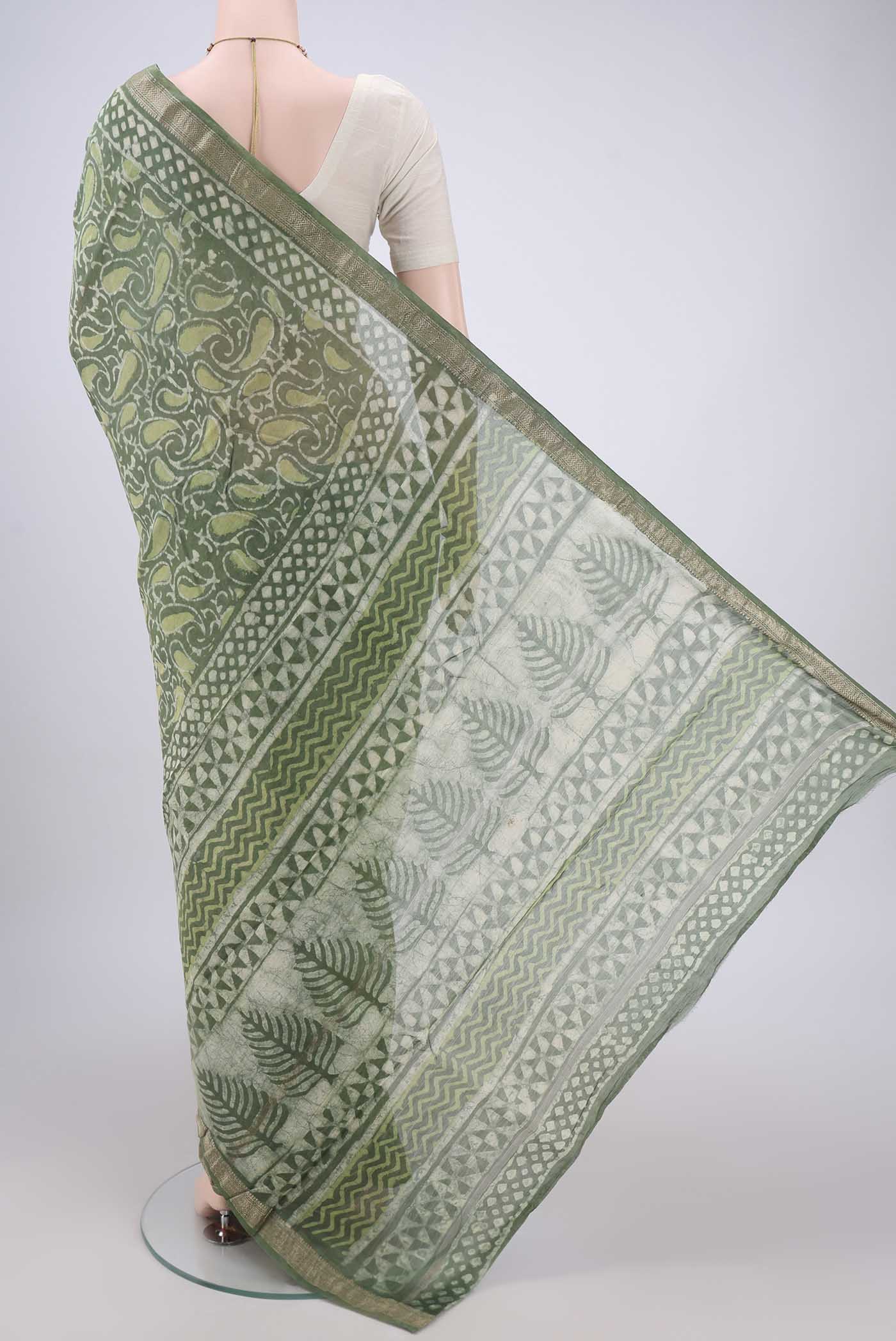Flat view of Olive Green Maheshwari Silk Cotton Saree with Batik Print on the body and Zari Border. 