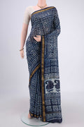 Indigo Maheshwari Silk Cotton Saree with Batik Print on the body and Zari Border.  displayed on a mannequin