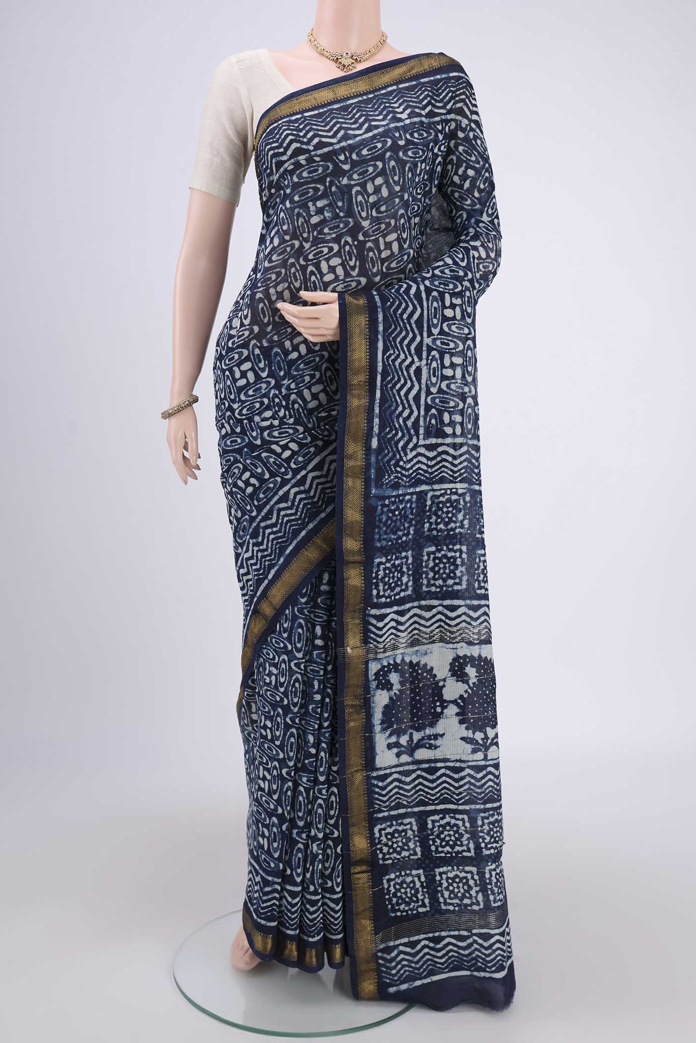 Indigo Maheshwari Silk Cotton Saree with Batik Print on the body and Zari Border.  displayed on a mannequin