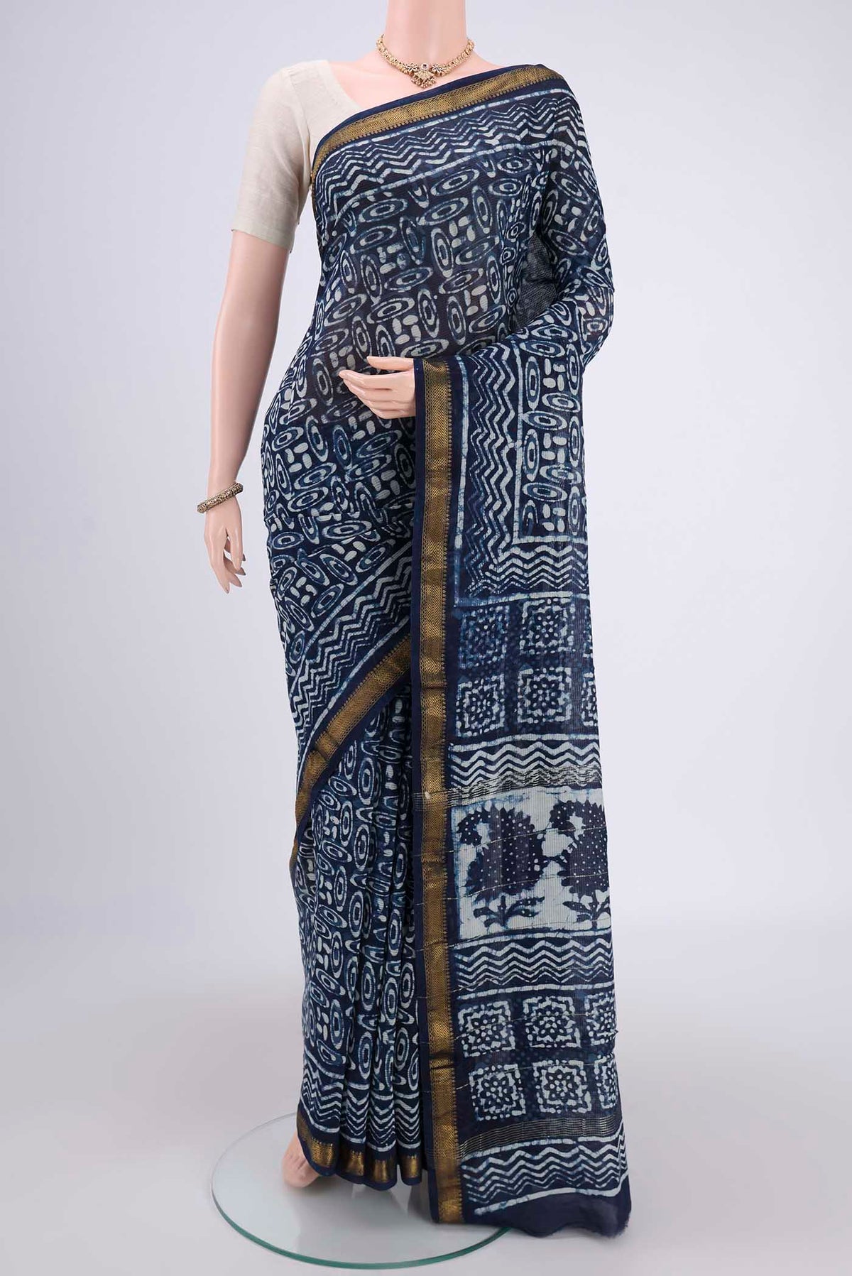 Indigo Maheshwari Silk Cotton Saree with Batik Print on the body and Zari Border.  displayed on a mannequin