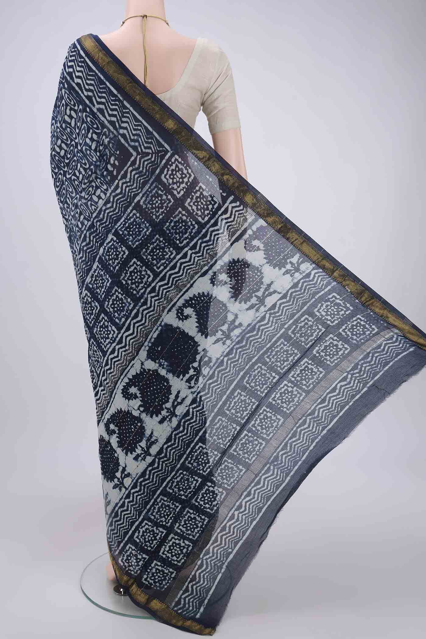 Flat view of Indigo Maheshwari Silk Cotton Saree with Batik Print on the body and Zari Border. 