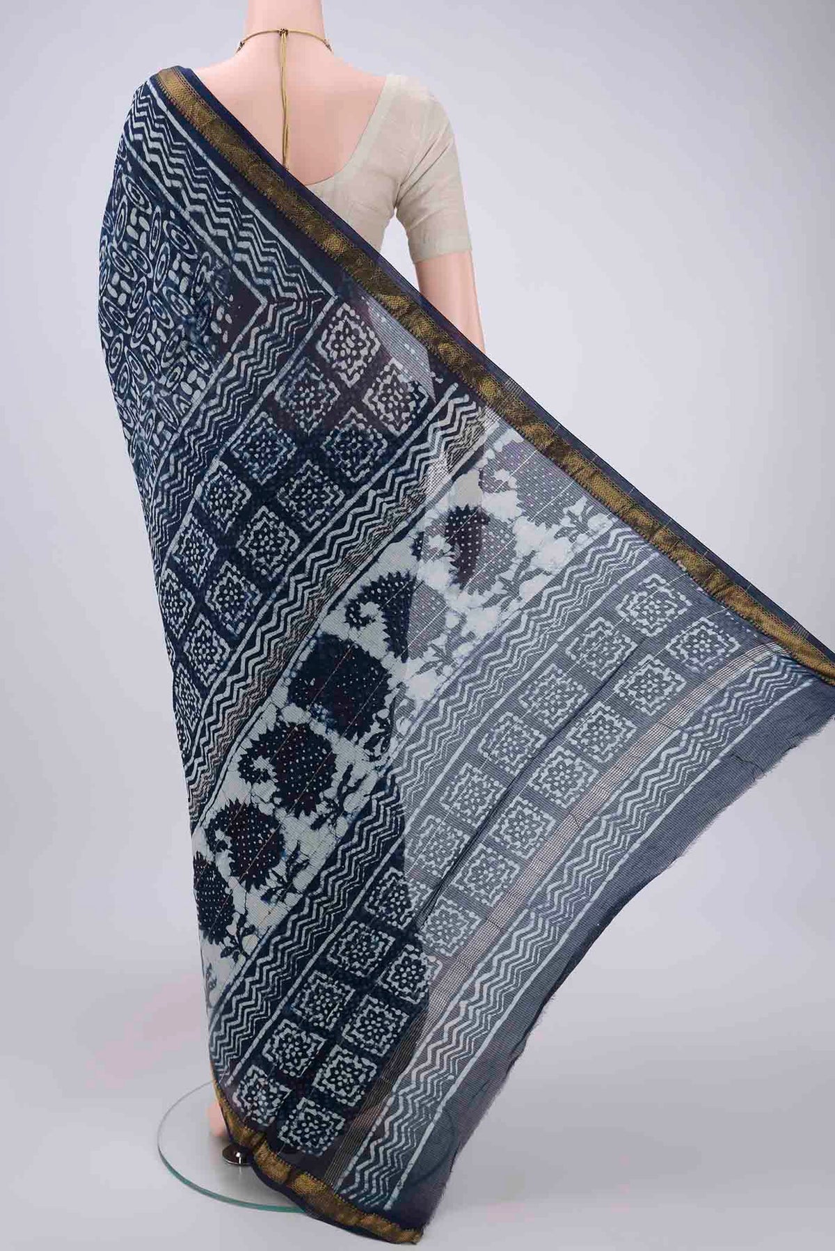 Flat view of Indigo Maheshwari Silk Cotton Saree with Batik Print on the body and Zari Border. 