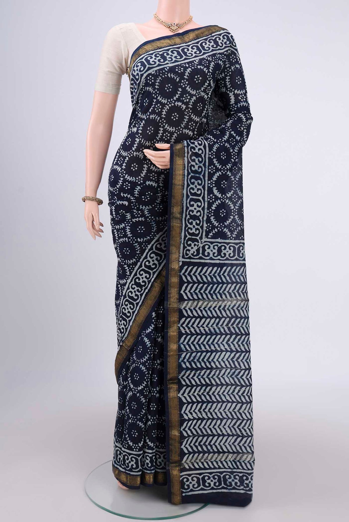 Indigo Maheshwari Silk Cotton Saree with Batik Print on the body and Zari Border.  displayed on a mannequin