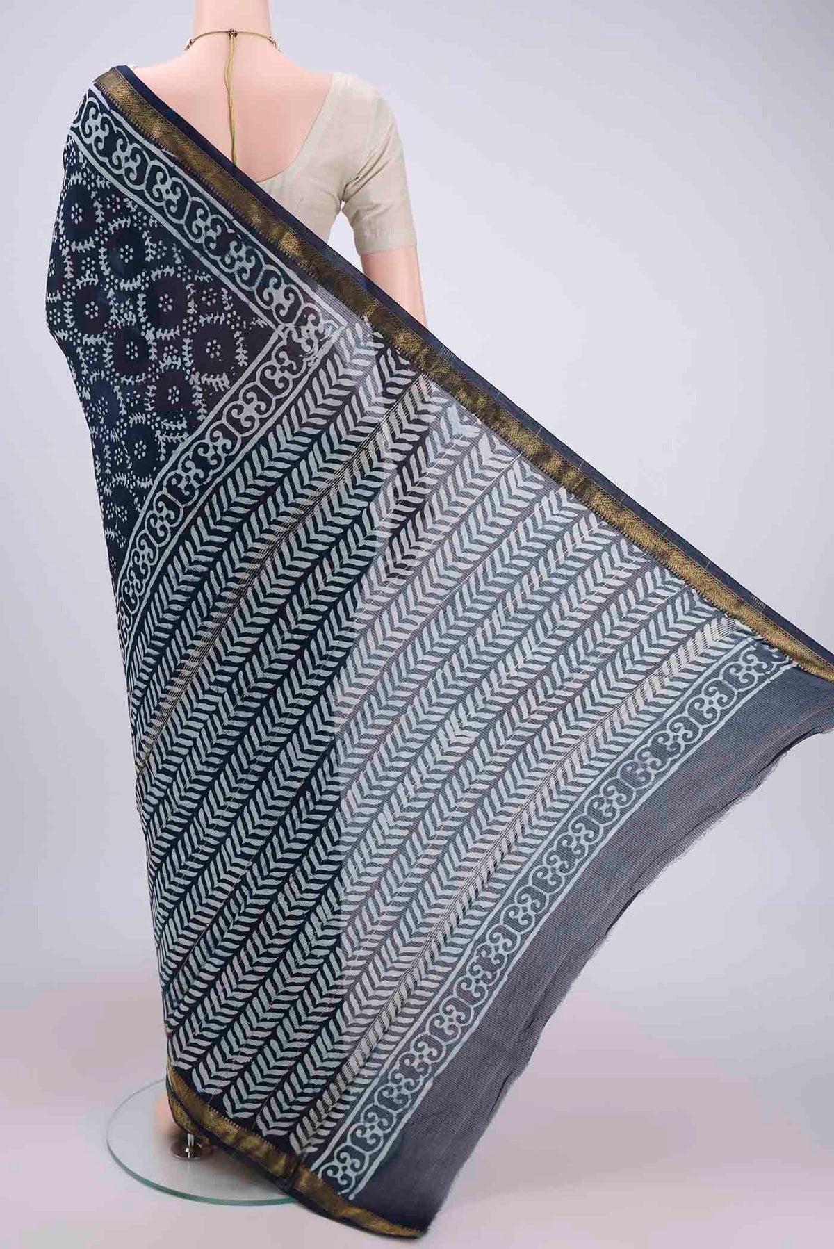 Flat view of Indigo Maheshwari Silk Cotton Saree with Batik Print on the body and Zari Border. 