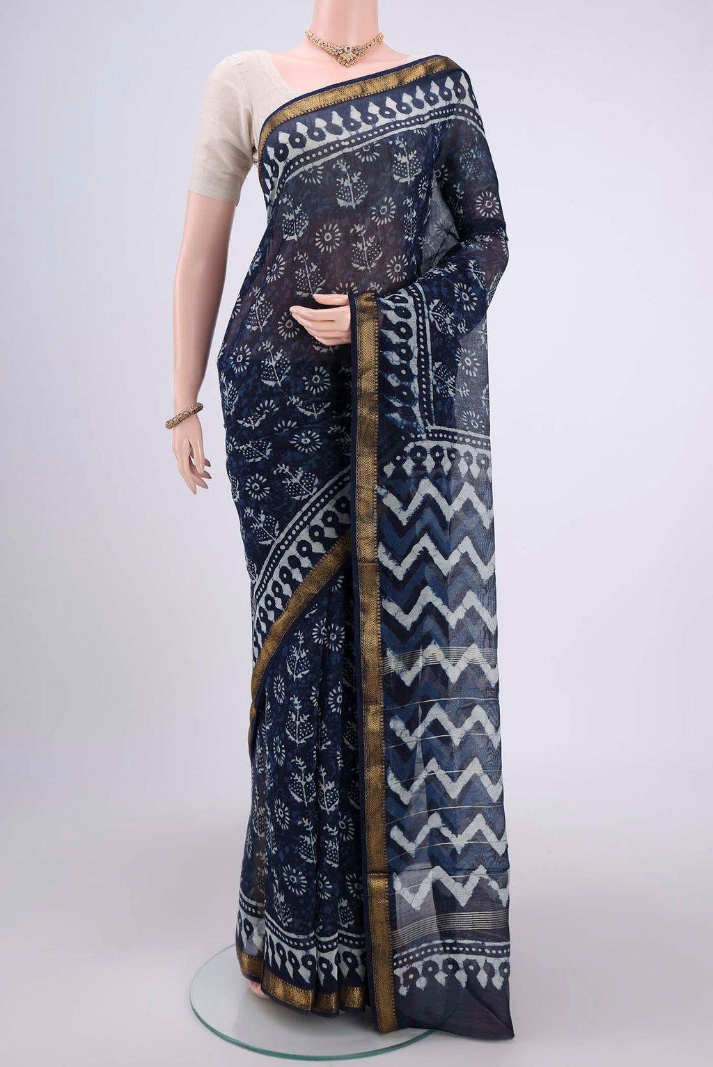 Indigo Maheshwari Silk Cotton Saree with Batik Print on the body and Zari Border.  displayed on a mannequin