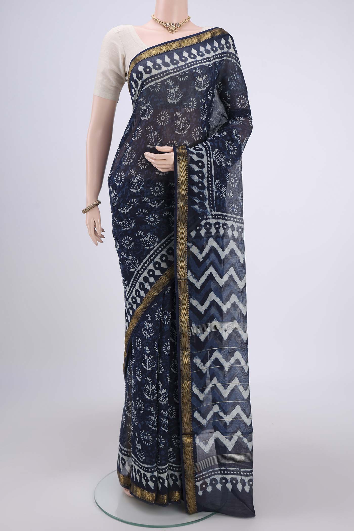 Indigo Maheshwari Silk Cotton Saree with Batik Print on the body and Zari Border.  displayed on a mannequin
