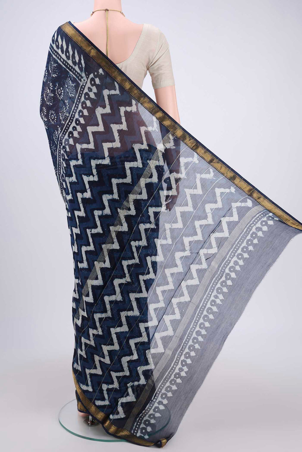 Flat view of Indigo Maheshwari Silk Cotton Saree with Batik Print on the body and Zari Border. 