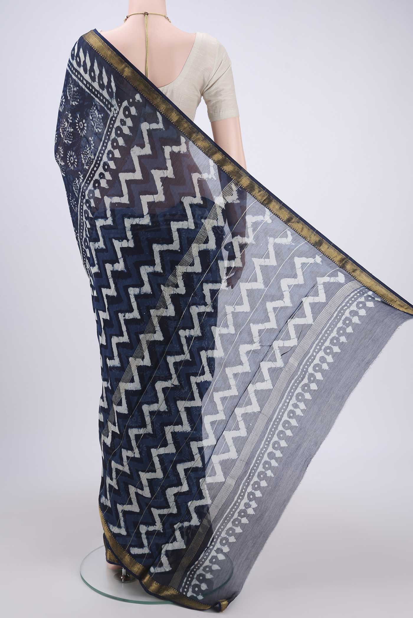 Flat view of Indigo Maheshwari Silk Cotton Saree with Batik Print on the body and Zari Border. 