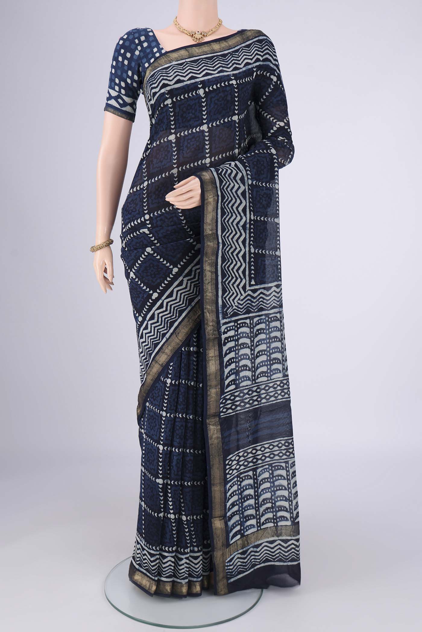 Indigo Maheshwari Silk Cotton Saree with Batik Print on the body and Zari Border.  displayed on a mannequin