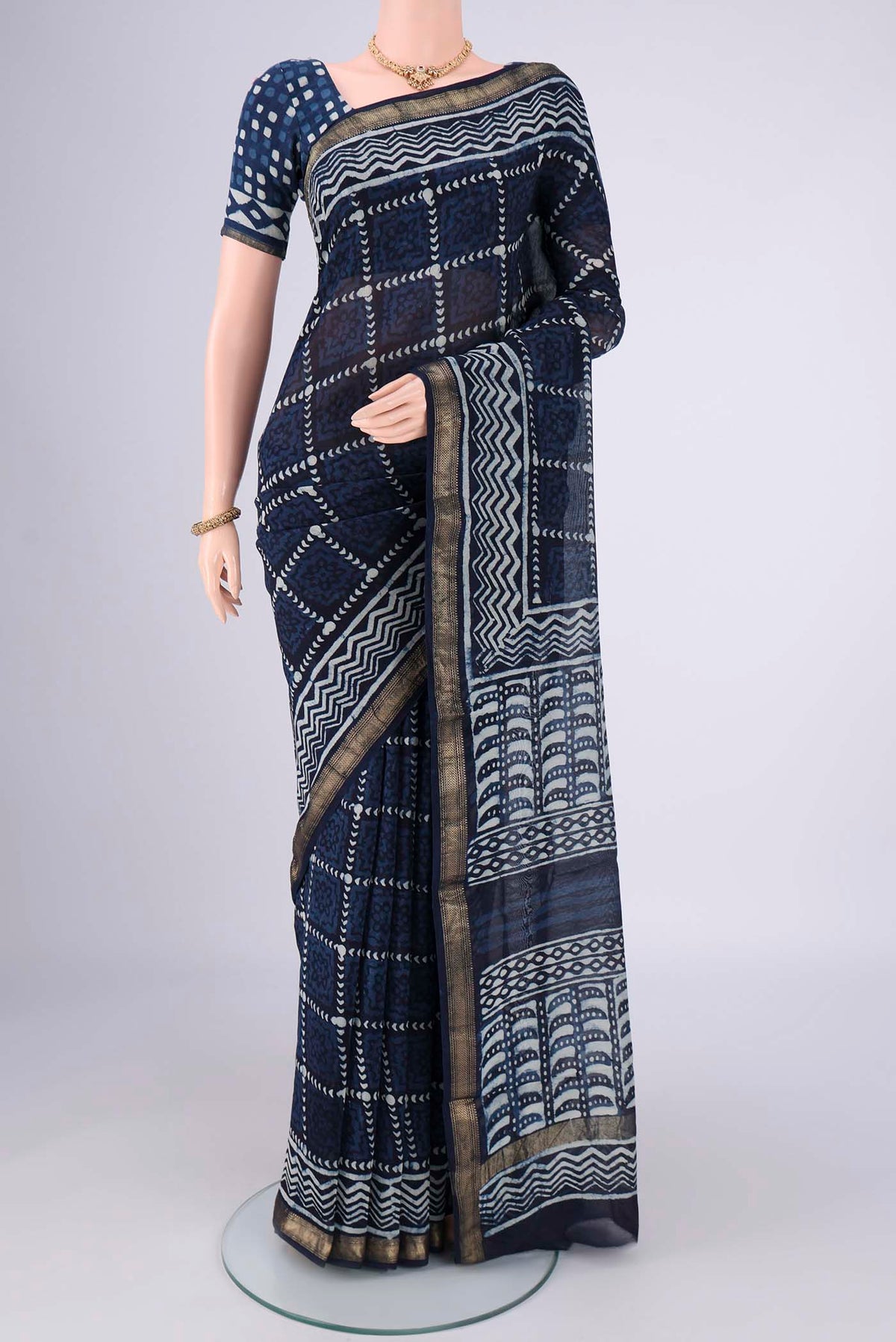 Indigo Maheshwari Silk Cotton Saree with Batik Print on the body and Zari Border.  displayed on a mannequin