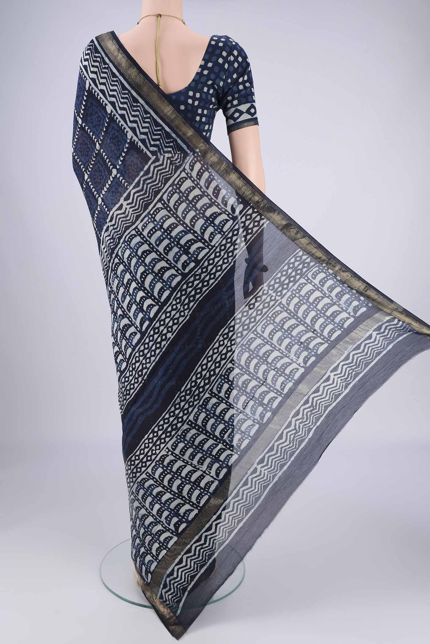 Flat view of Indigo Maheshwari Silk Cotton Saree with Batik Print on the body and Zari Border. 