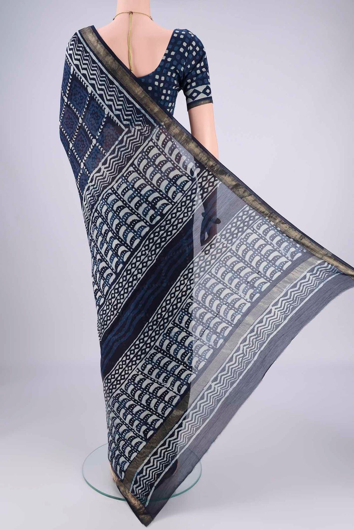 Flat view of Indigo Maheshwari Silk Cotton Saree with Batik Print on the body and Zari Border. 
