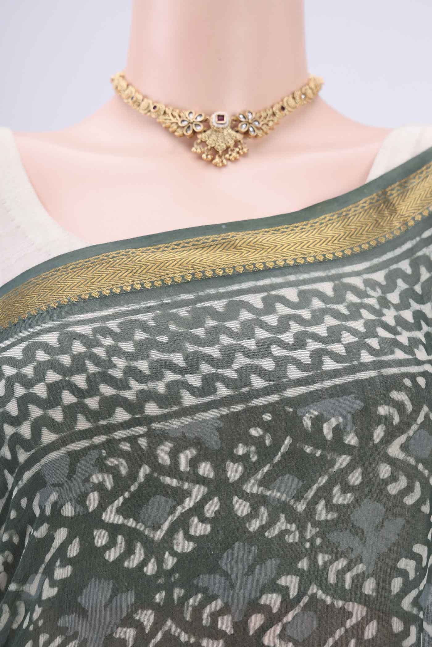 Border image of Olive Green Maheshwari Silk Cotton Saree with Batik Print on the body and Zari Border. 